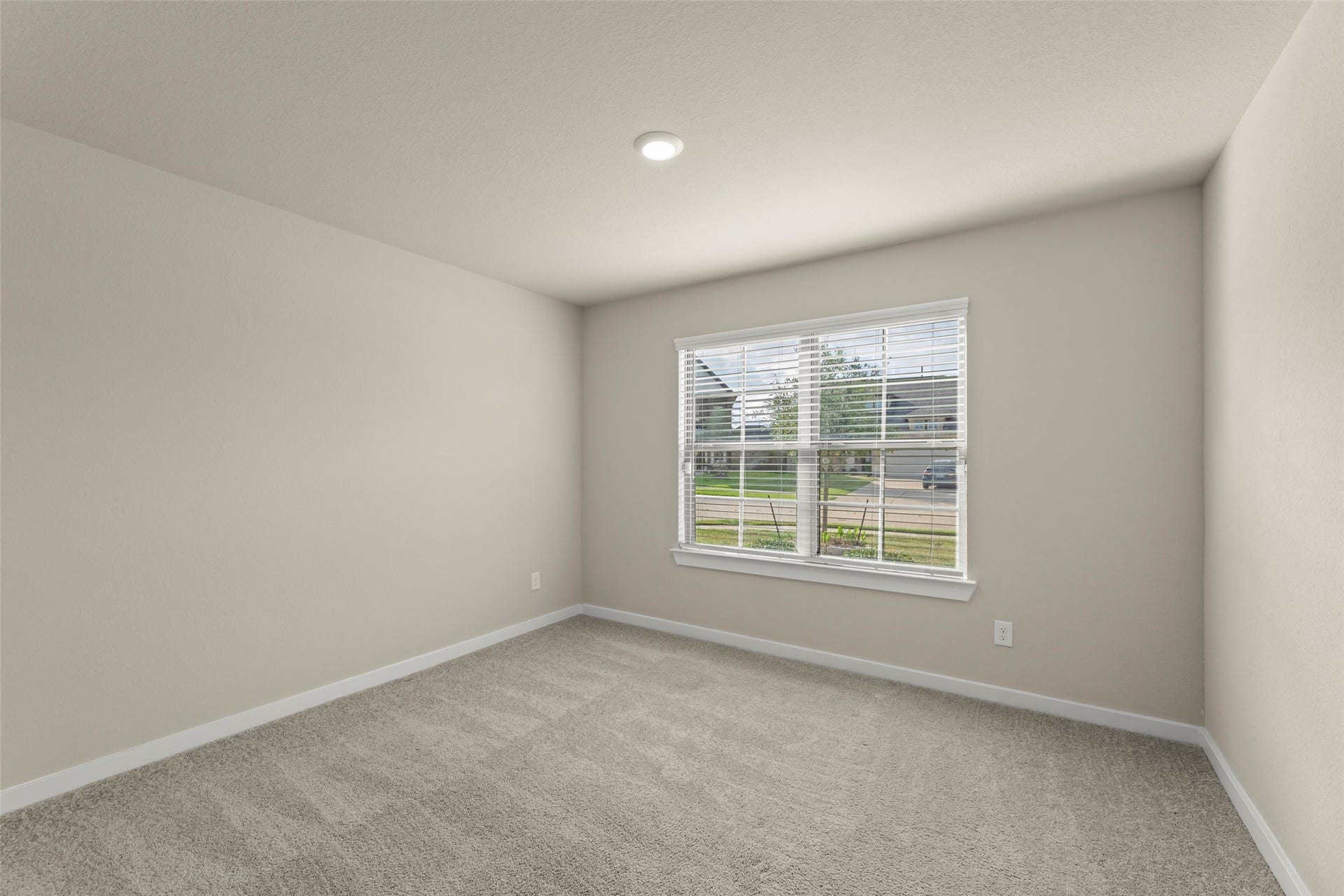 2610 Blue Abbot Drive, Fresno, TX 77545 Bright, spacious room with neutral walls, plush carpeting, and a large window offering plenty of natural light.