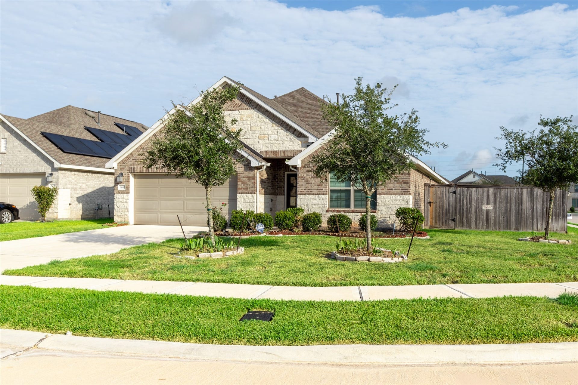 2610 Blue Abbot Drive, Fresno, TX 77545 Welcoming well-maintained landscaping, complete with mature trees.
