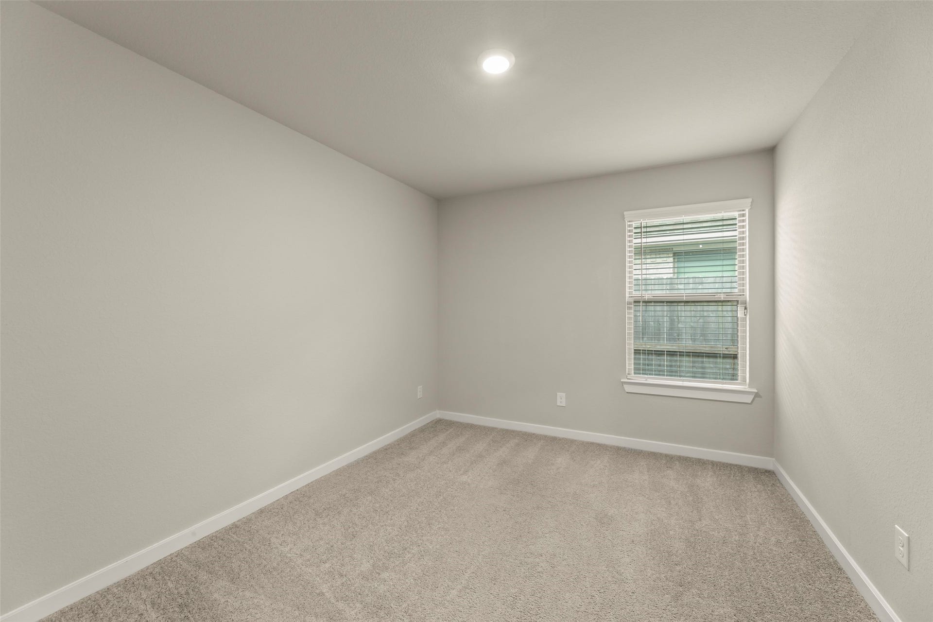 2610 Blue Abbot Drive, Fresno, TX 77545 Cozy room with soft carpeting, neutral walls, and a window allowing natural light to flow in.