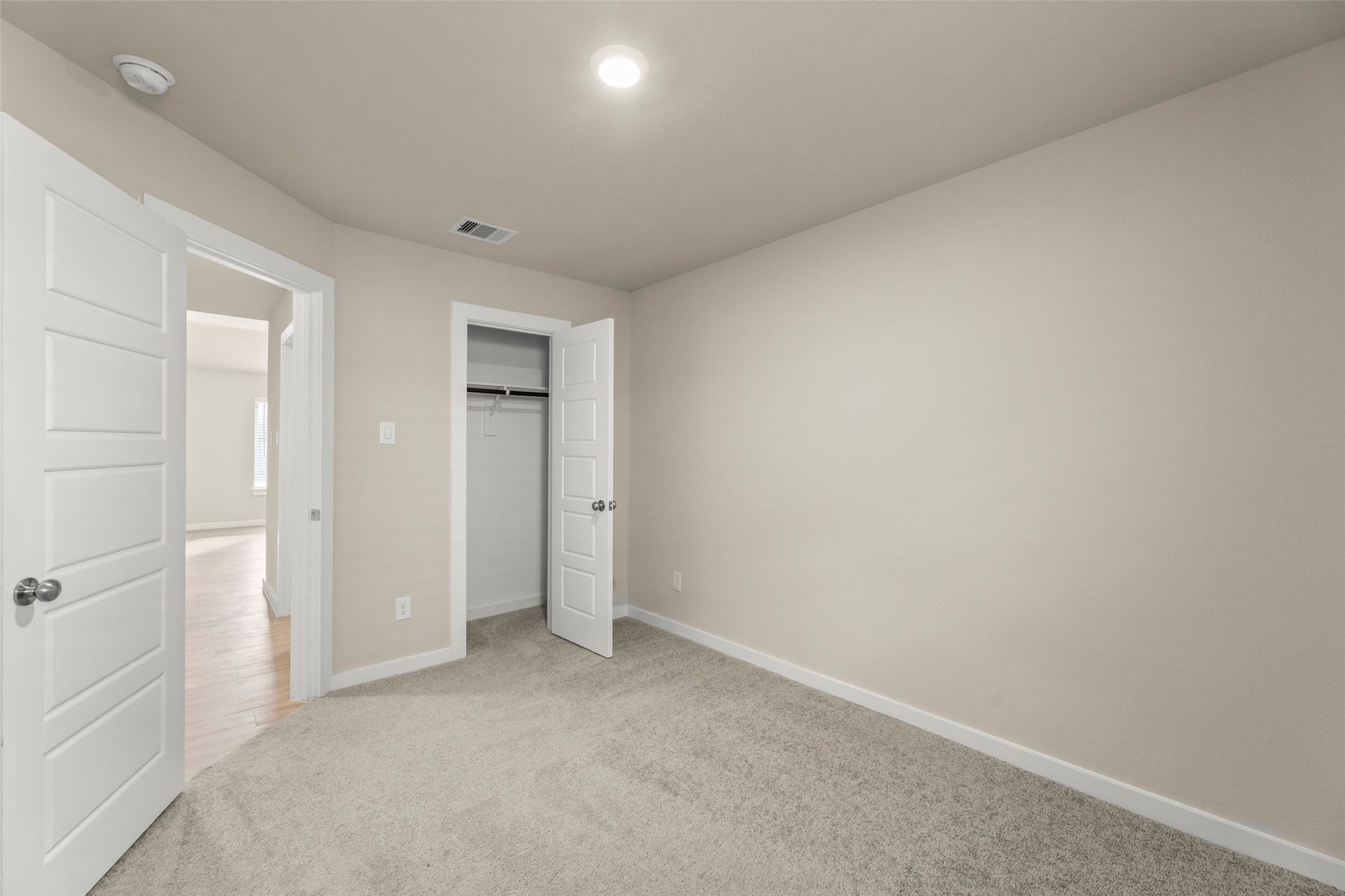 2610 Blue Abbot Drive, Fresno, TX 77545 Warm bedroom featuring soft carpet flooring and a spacious closet, enhanced by neutral tones for a serene atmosphere.