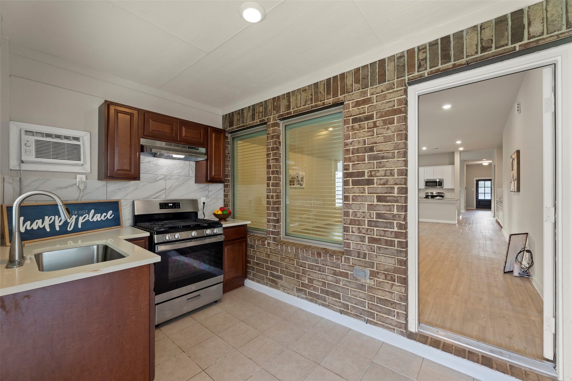 2610 Blue Abbot Drive, Fresno, TX 77545 Rich wood cabinetry and stainless steel appliances connects to a bright, spacious hallway, offering a seamless flow throughout the home.