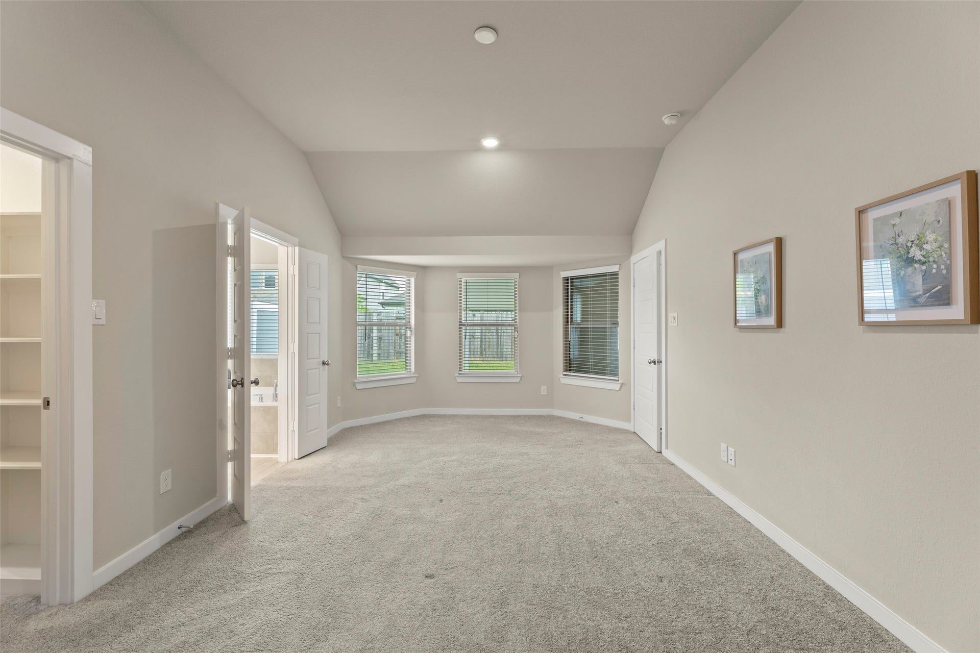 2610 Blue Abbot Drive, Fresno, TX 77545 Plush carpeting, featuring large windows that invite abundant natural light, and an ensuite bathroom for added convenience.