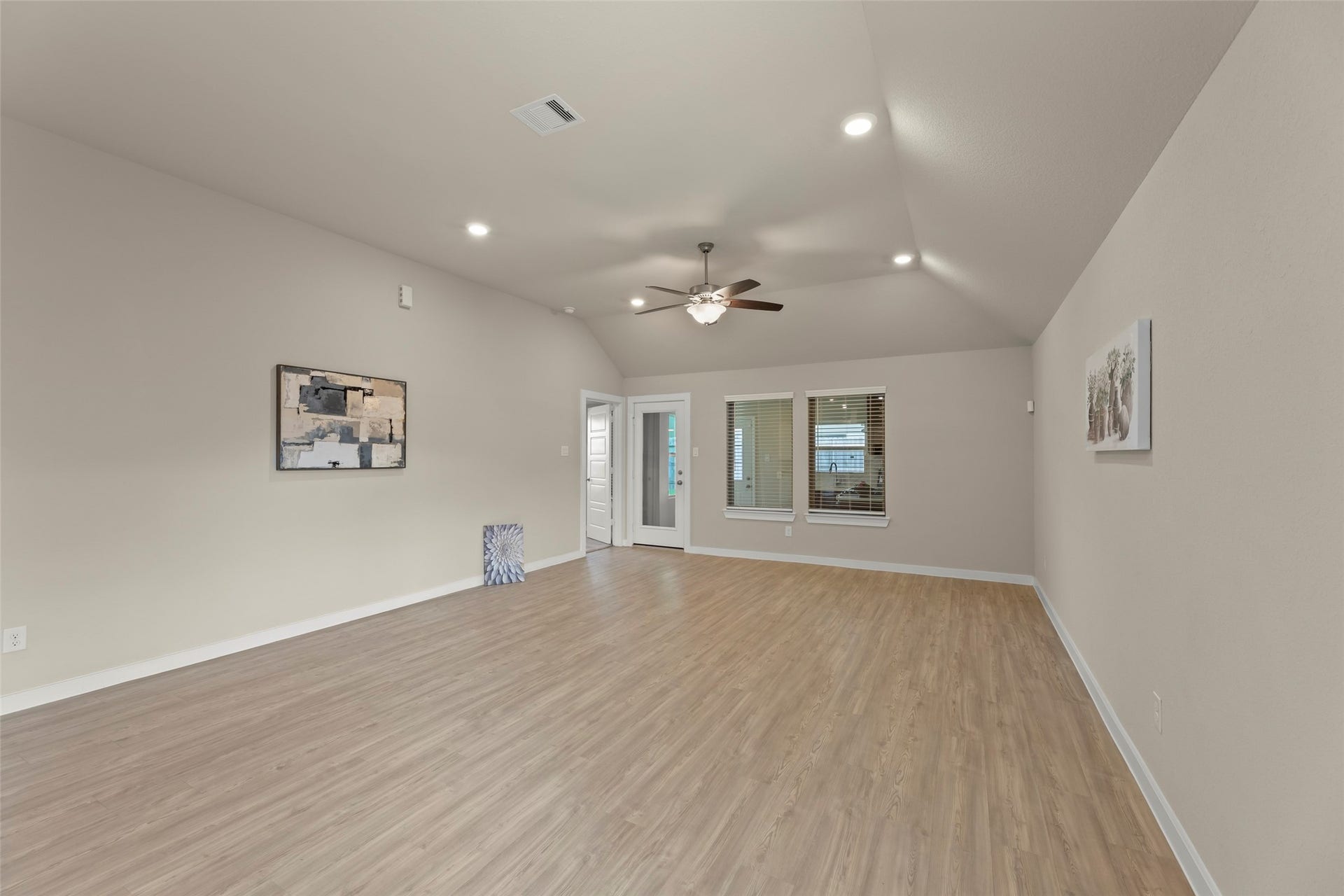 2610 Blue Abbot Drive, Fresno, TX 77545 Comfortable living area with vaulted ceilings, recessed lighting, and elegant wood flooring, offering a bright and open ambiance.