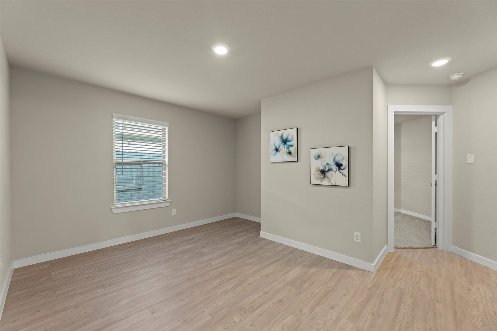 2610 Blue Abbot Drive, Fresno, TX 77545 Inviting room with sleek wood flooring, soft neutral walls, and recessed lighting, perfect for a cozy retreat or home office.