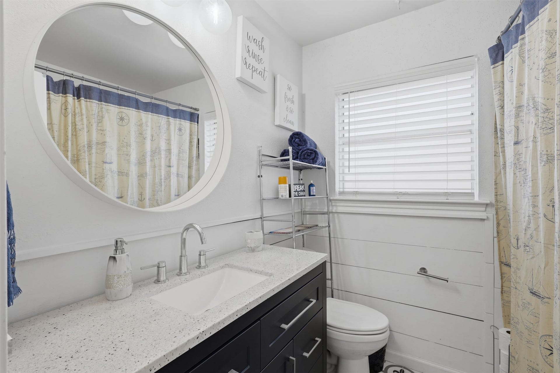 Full secondary bathroom features a tub/shower combination and convenient vanity storage.