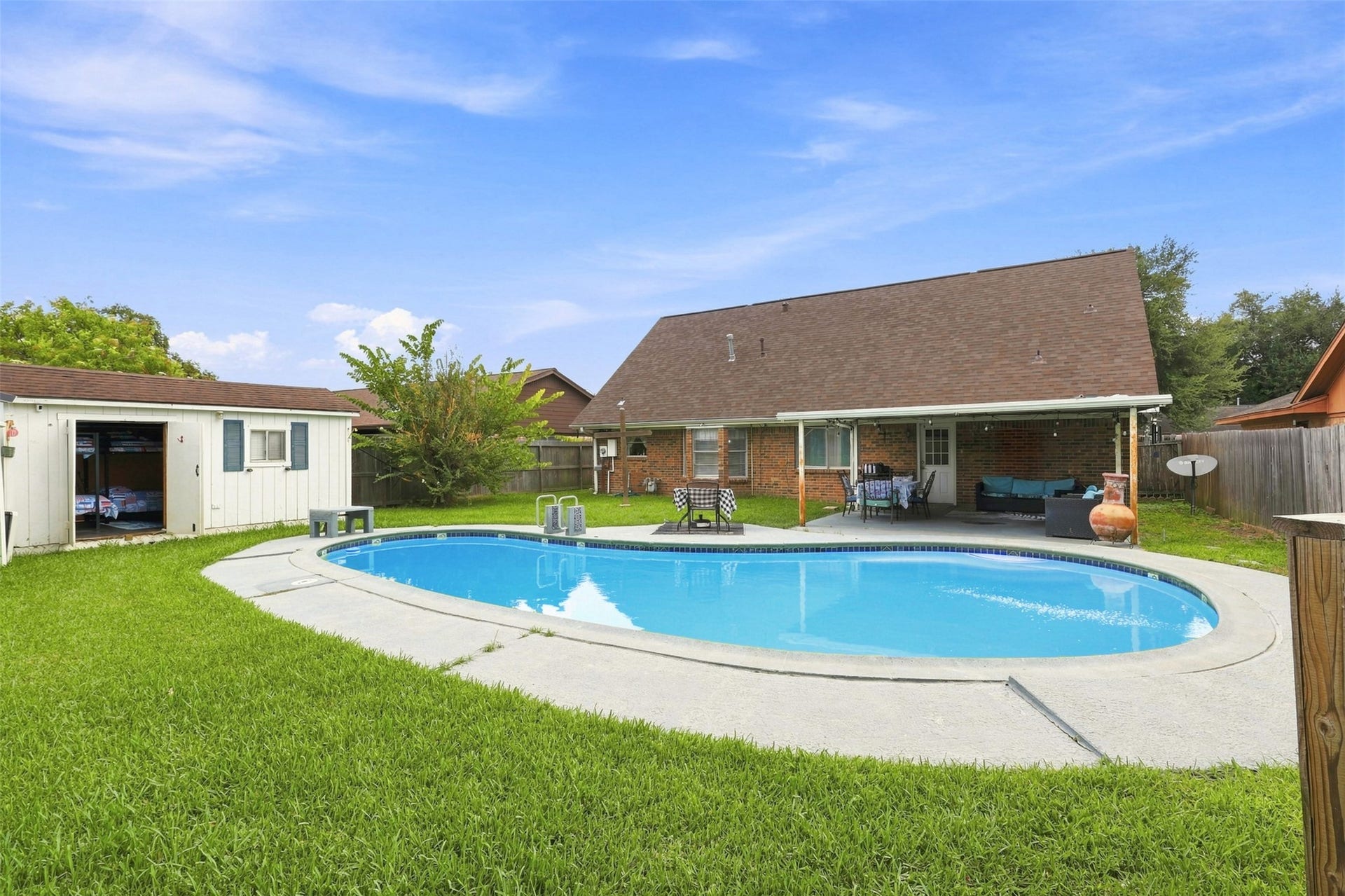 Spacious fenced backyard centers around an inviting in-ground pool ready for warm Texas days.