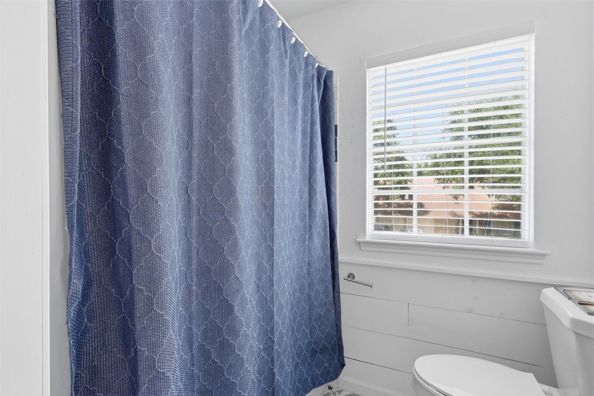Bright primary bath features a tub/shower combination, stylish vanity, and a clean, functional layout.