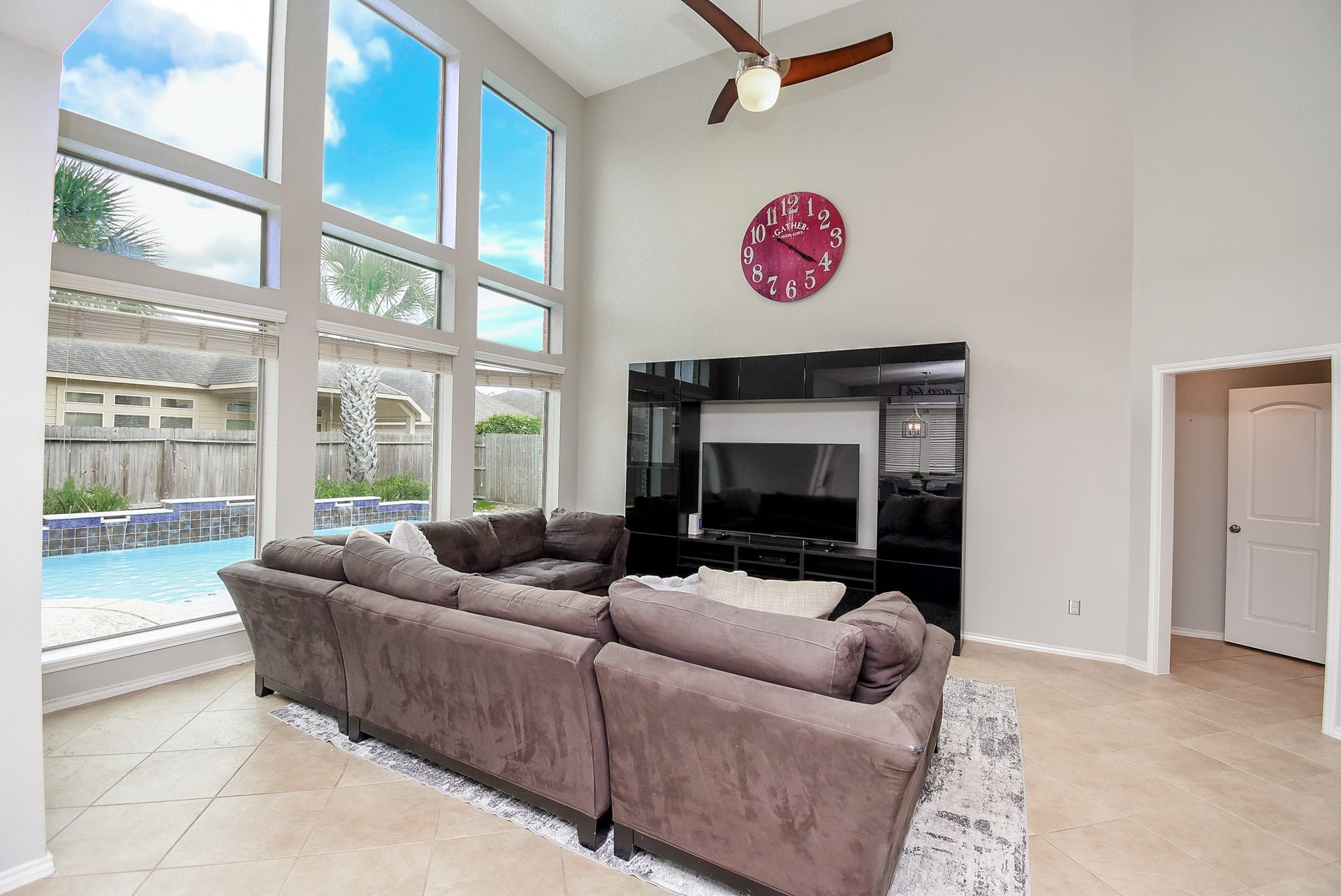 1334 Laura Hills Lane, Spring, TX 77386 The living room features a wall of windows to enjoy views of the backyard oasis!