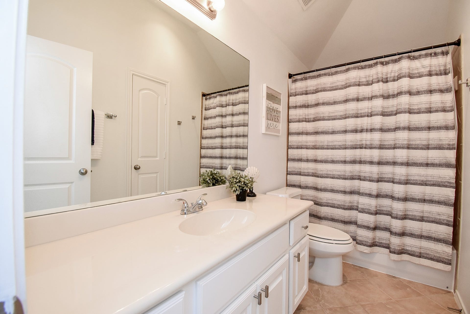 1334 Laura Hills Lane, Spring, TX 77386 Bathroom 3 has extra vanity counter space and tile shower surround.