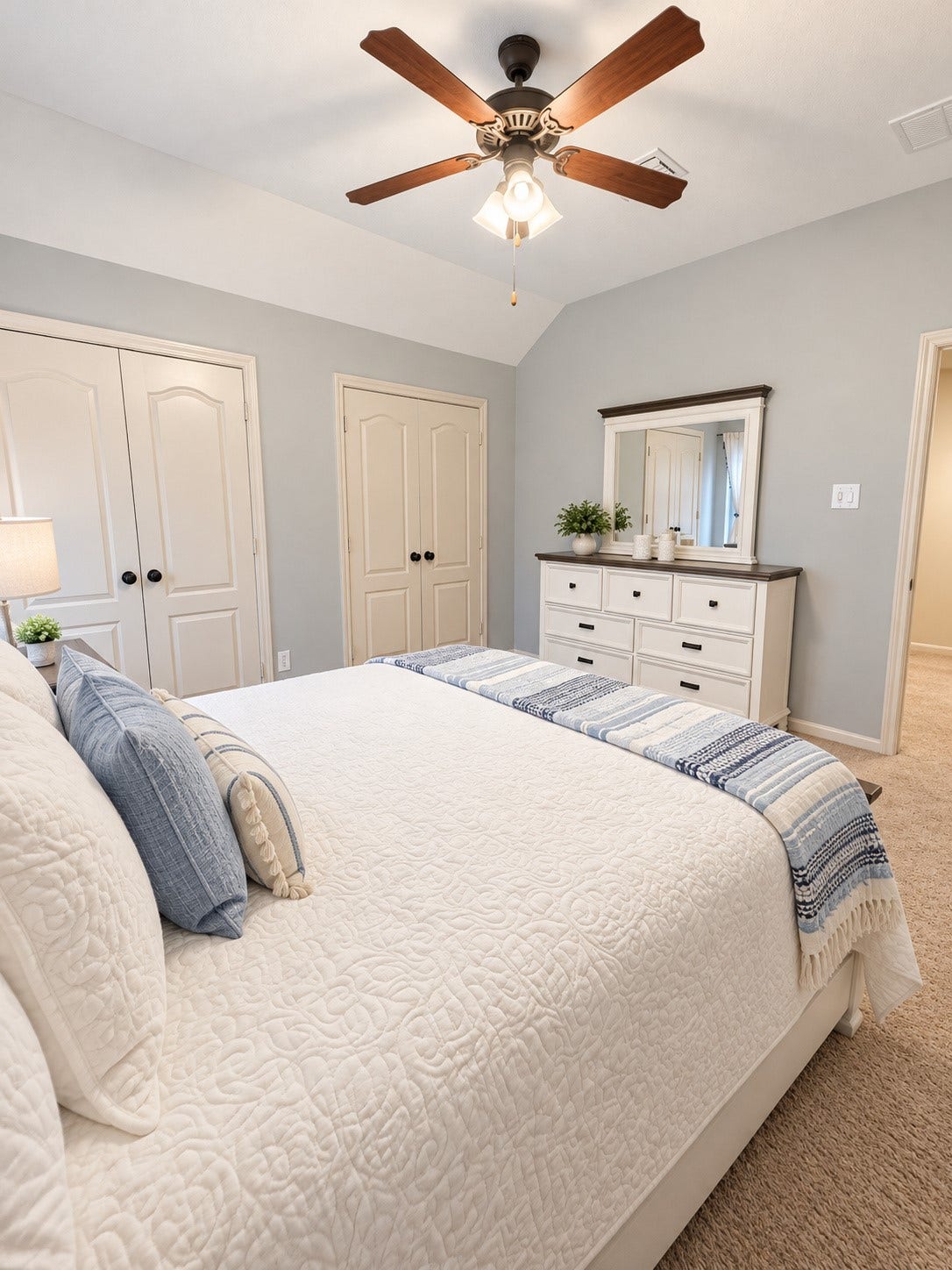 14215 Windy Crossing Lane, Humble, TX 77396 Comfortable secondary bedroom with vaulted ceiling, soft carpeting, and ample natural light.