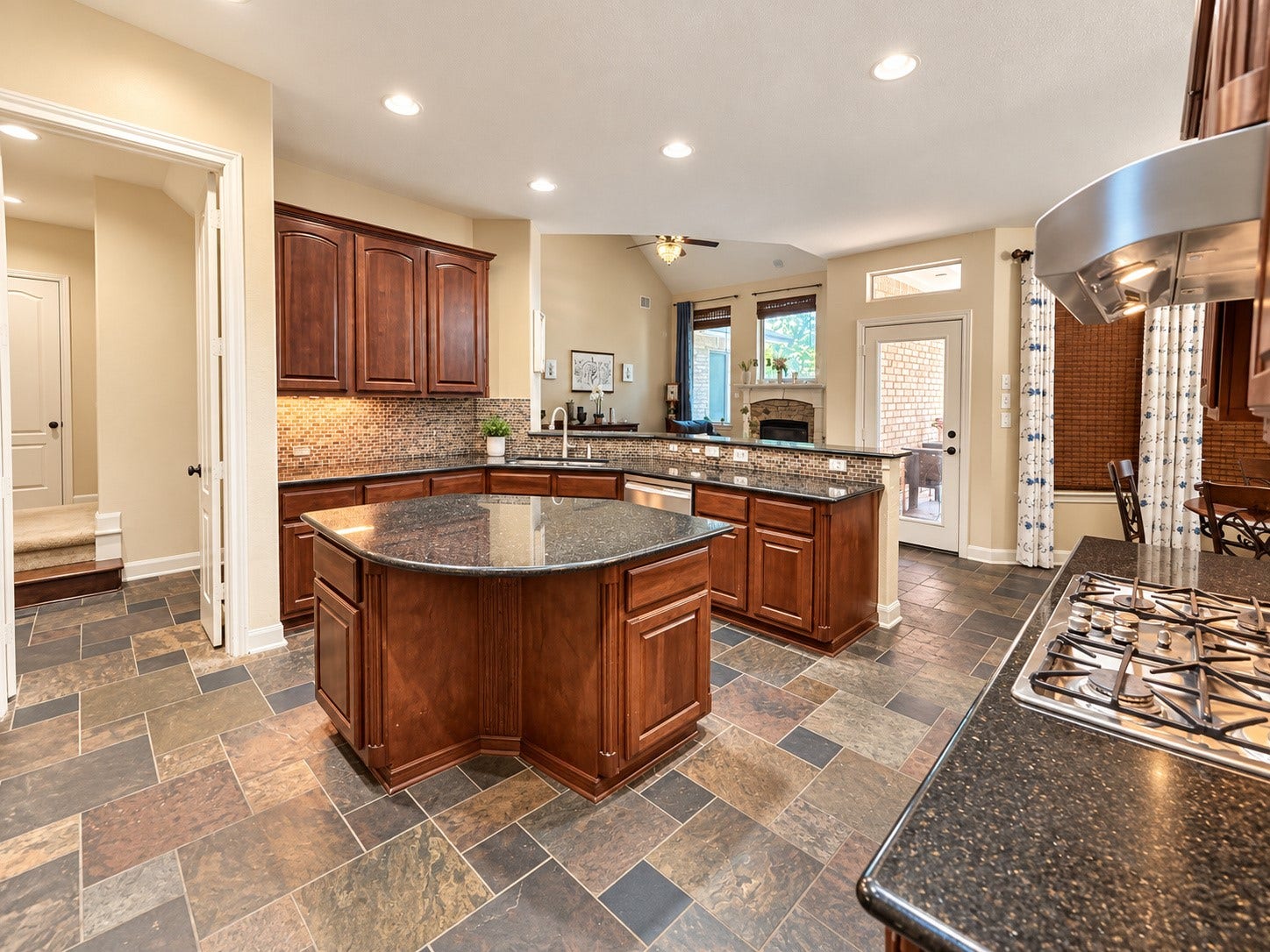 14215 Windy Crossing Lane, Humble, TX 77396 Functional center island provides additional preparation space and enhances the kitchen's inviting layout.