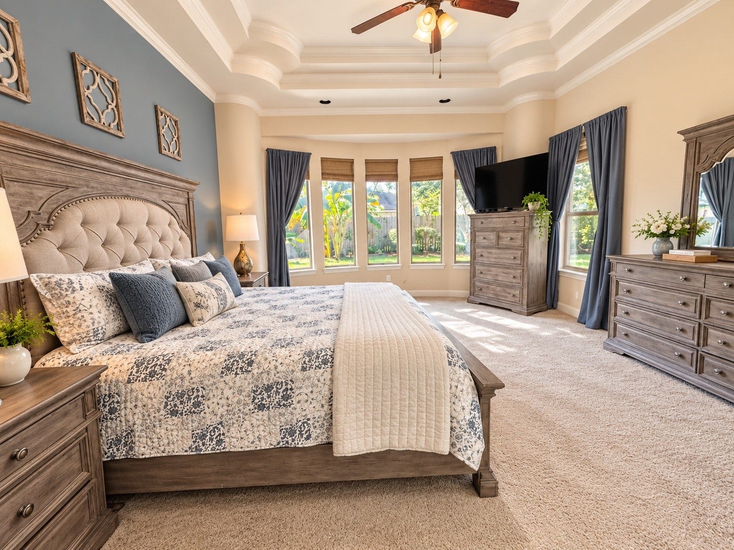14215 Windy Crossing Lane, Humble, TX 77396 Relaxing primary bedroom with a decorative accent wall, generous floor space, and attractive ceiling details.