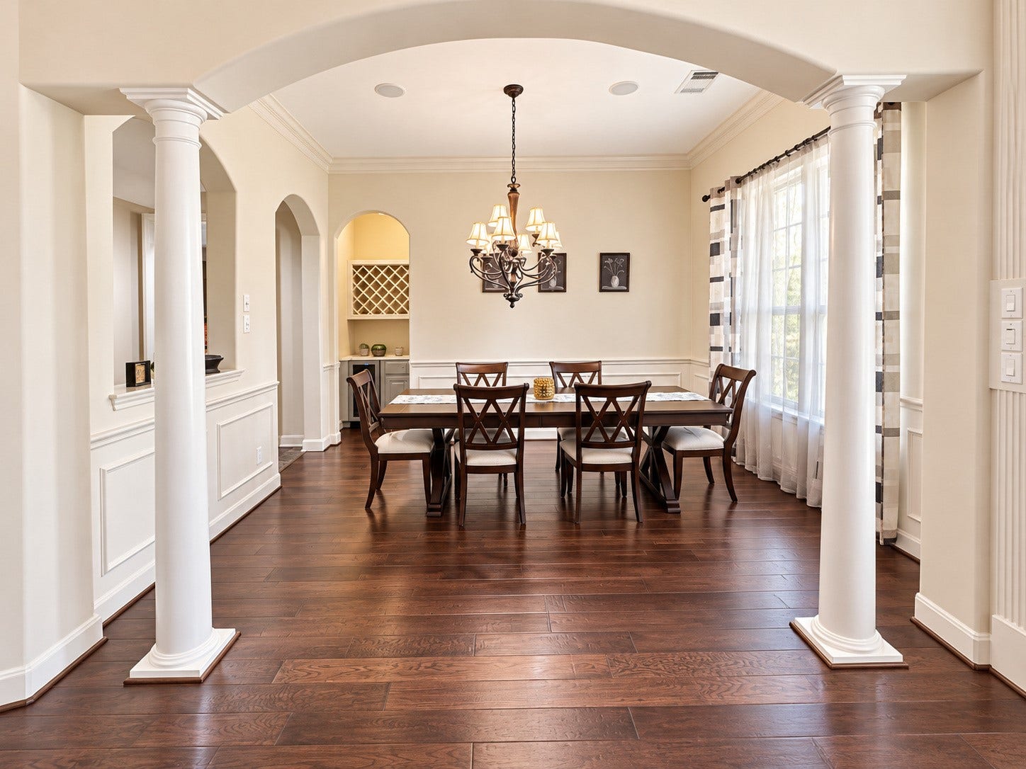 14215 Windy Crossing Lane, Humble, TX 77396 Beautiful formal dining room with crown molding, elegant chandelier, and classic wainscoting.arched openings, and an inviting view into the home.