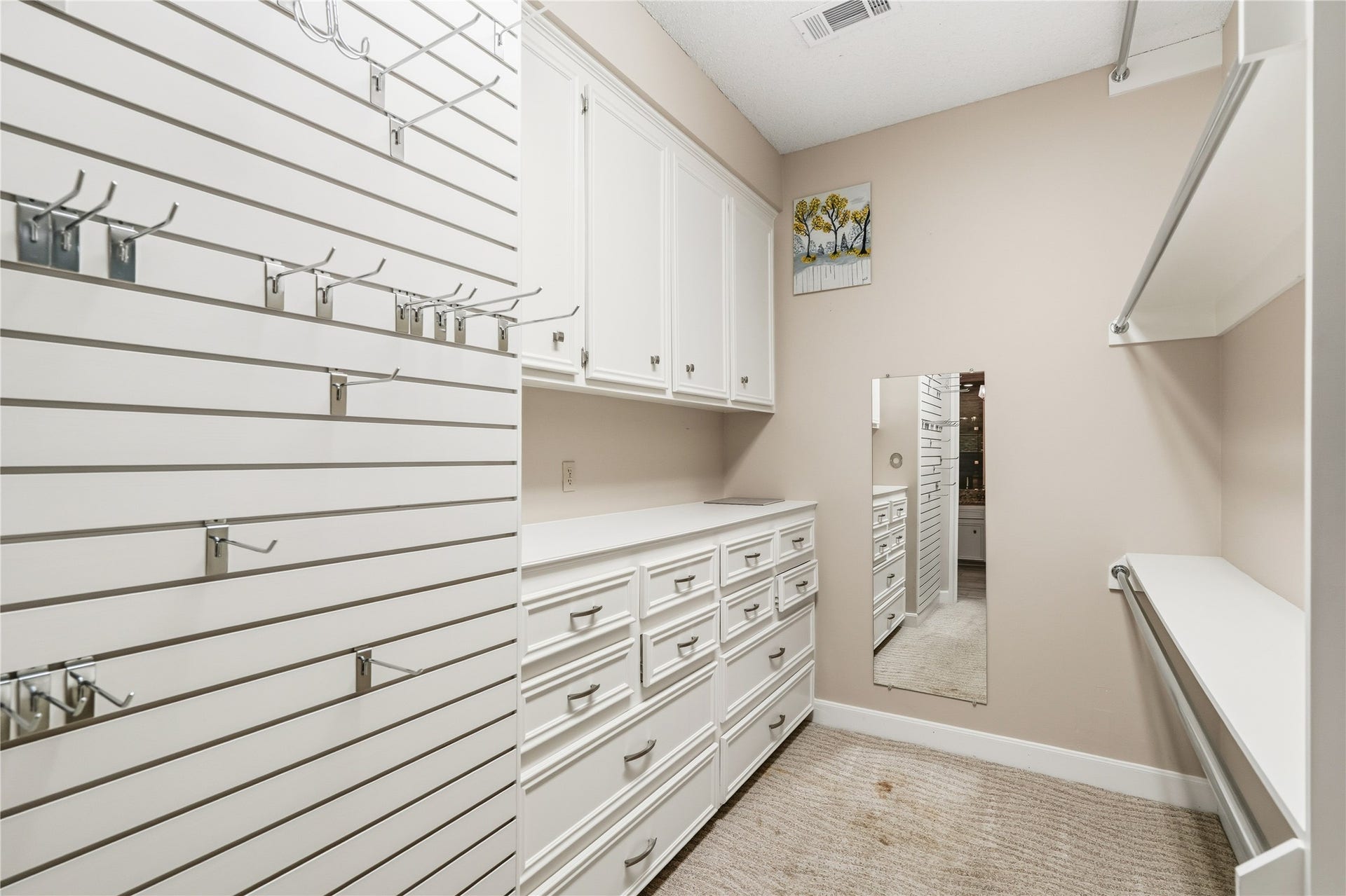 218 Bella Vista Drive, Richmond, TX 77406 Spacious walk-in closet featuring ample built-in storage with cabinets, drawers, and versatile hanging space, perfect for organizing your wardrobe.