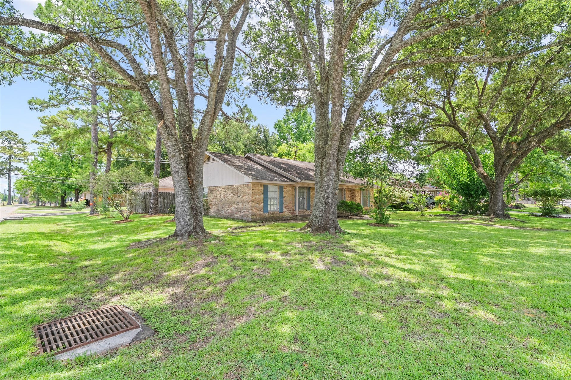 2001 Lamar Drive, Richmond, TX 77469 The spacious lot is enhanced by mature trees, creating a picturesque landscape with natural beauty and year-round shade.