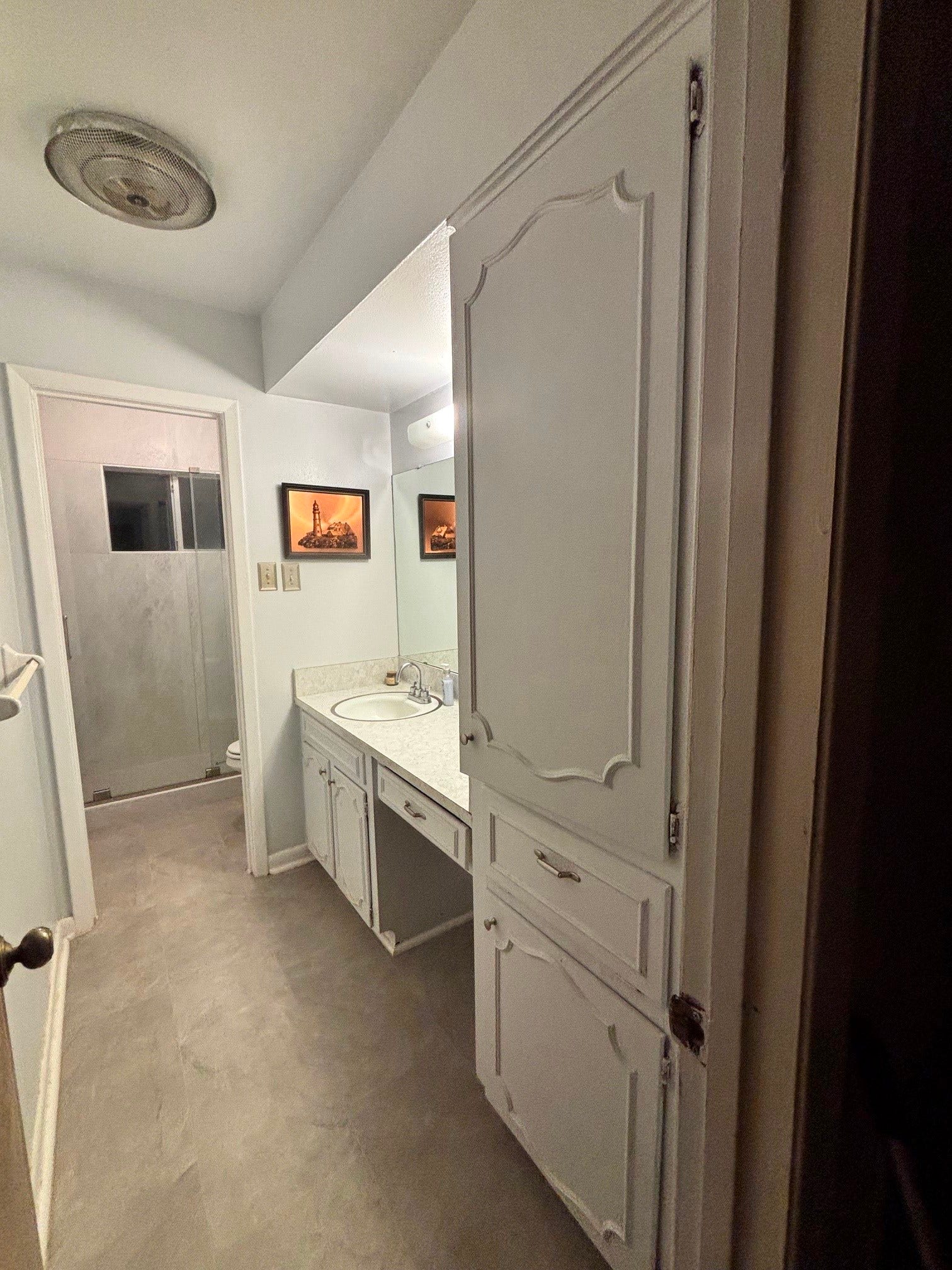 2001 Lamar Drive, Richmond, TX 77469 This bathroom offers a functional layout with the sink vanity in one room and a walk-in shower and toilet in a separate area, providing added convenience and privacy.