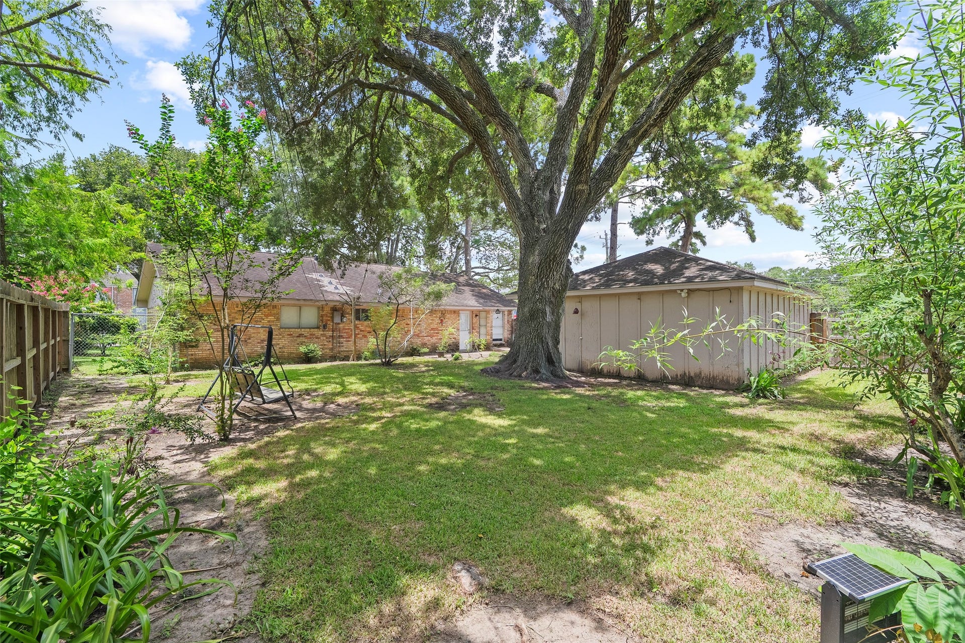 2001 Lamar Drive, Richmond, TX 77469 The generous backyard is surrounded by mature trees that provide ample shade, offering a cool and inviting space to enjoy the outdoors year-round.