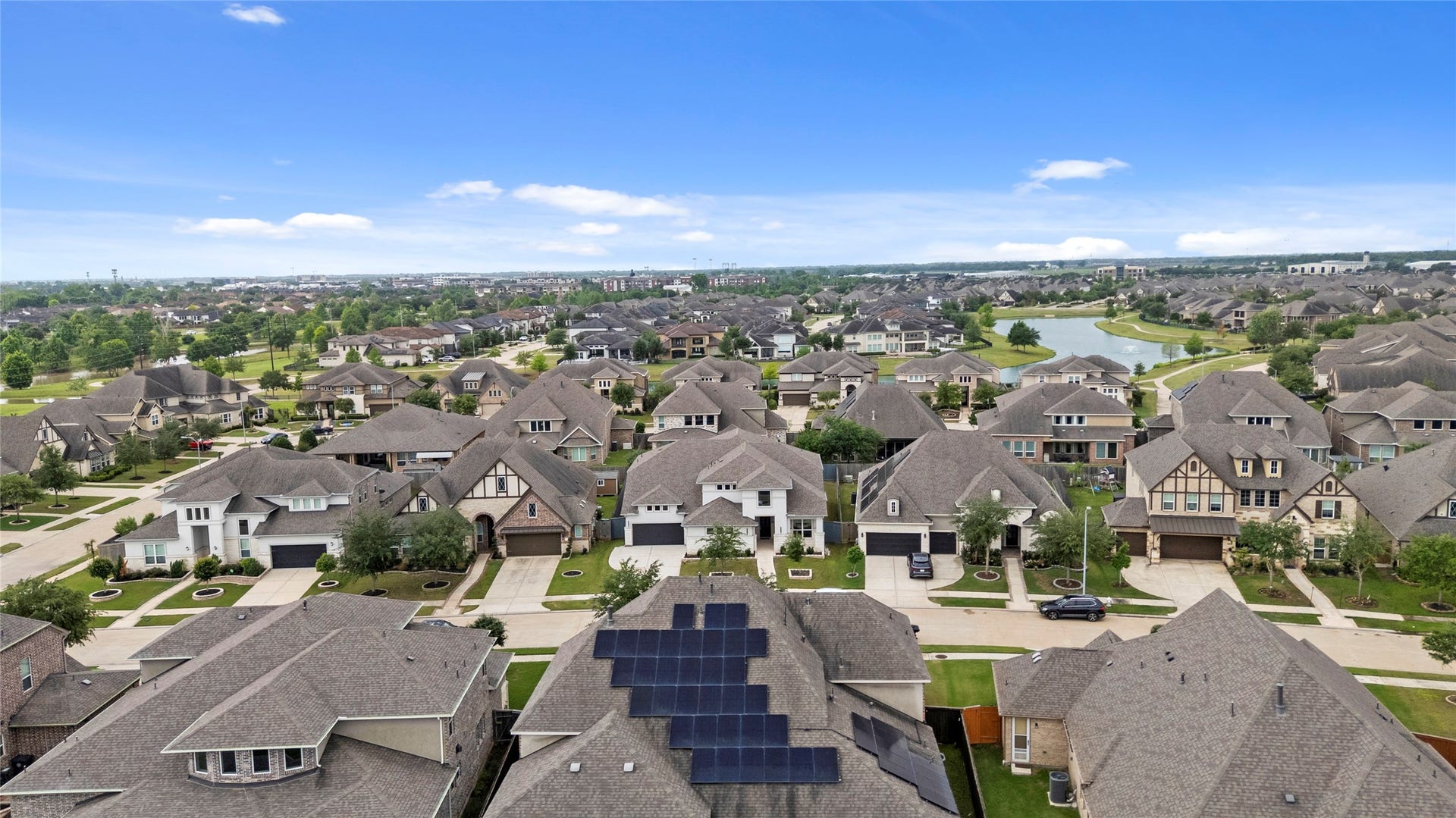 11 Victorian Run, Sugar Land, TX 77498 Scenic aerial view of a well-planned community featuring beautiful homes, peaceful streets, and a nearby lake backdrop.