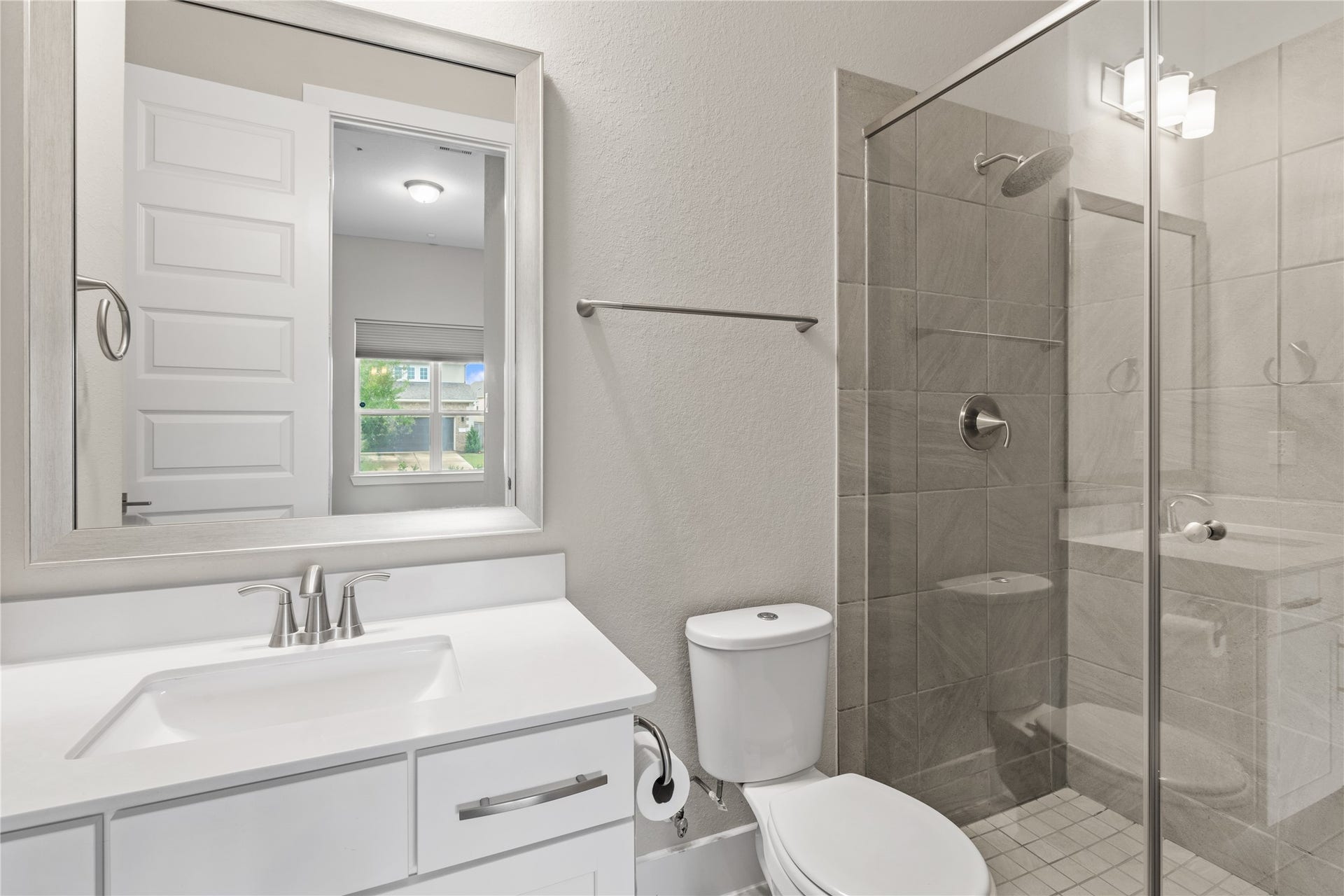 11 Victorian Run, Sugar Land, TX 77498 Well-appointed bathroom featuring a sleek vanity with ample counter space, a framed mirror, and a glass-enclosed walk-in shower with modern tile finishes.