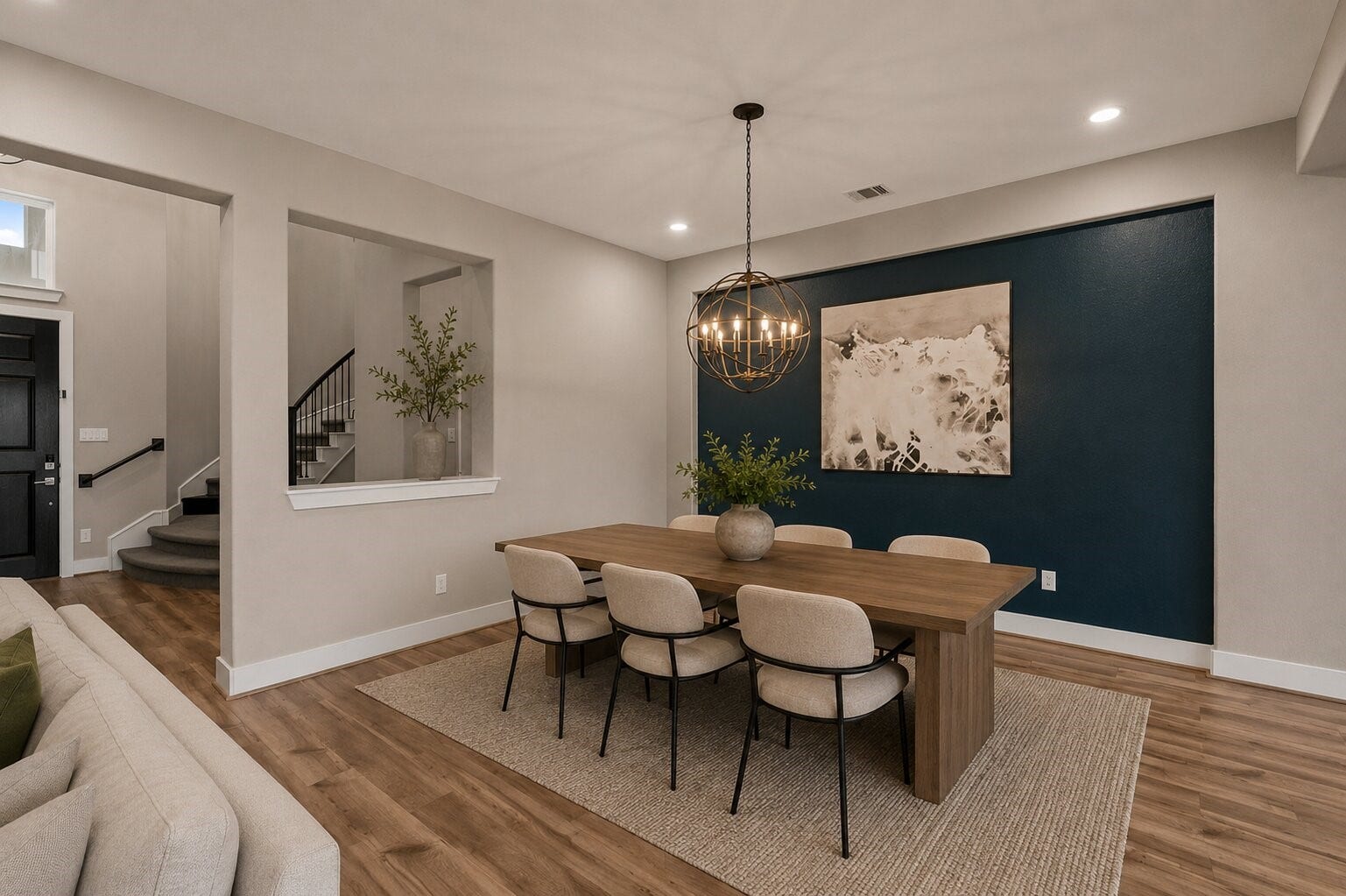 11 Victorian Run, Sugar Land, TX 77498 Inviting dining space with a bold accent wall, contemporary chandelier, and open sightlines to the foyer, creating a perfect setting for both everyday meals and entertaining.