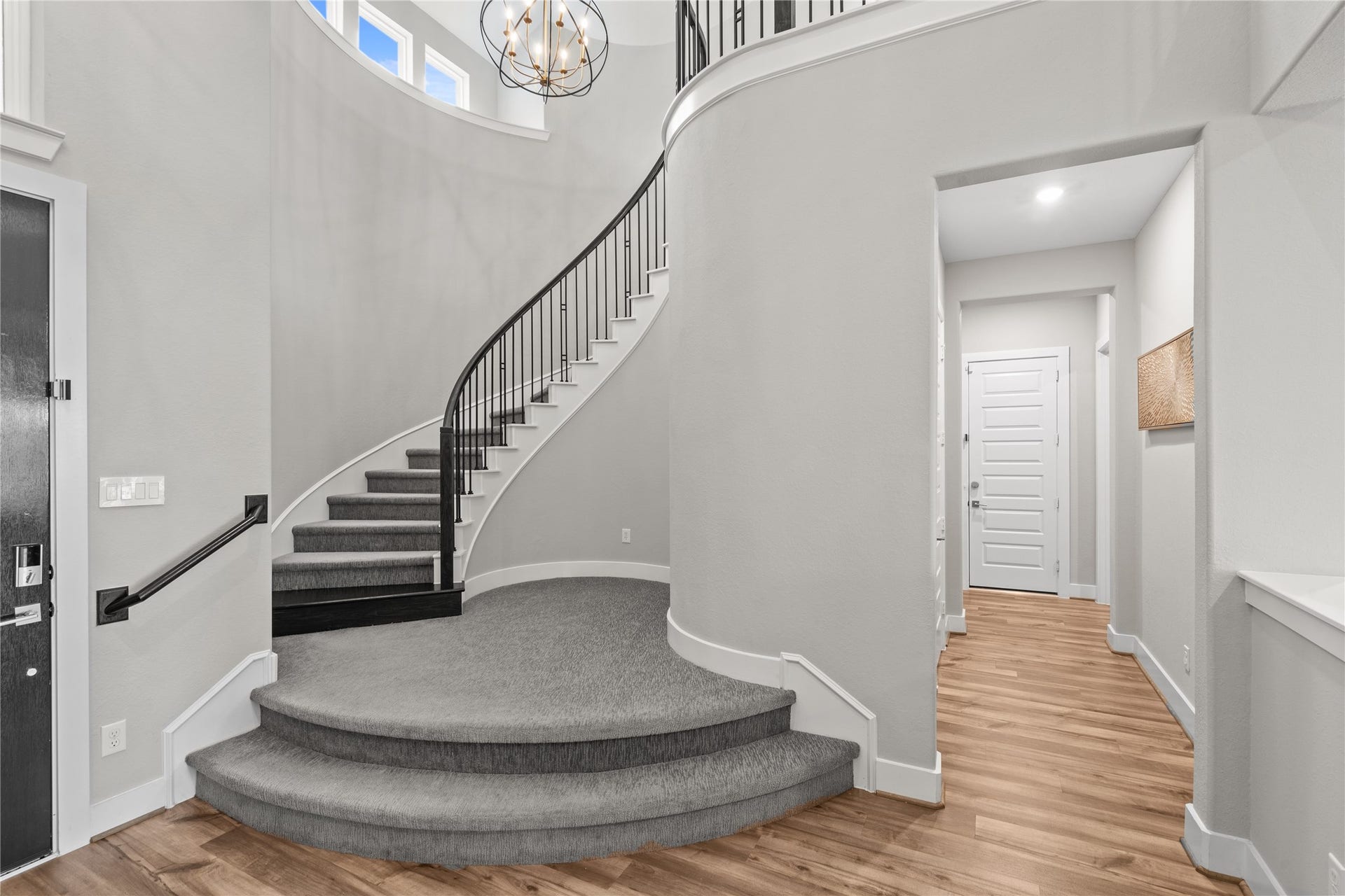 11 Victorian Run, Sugar Land, TX 77498 Impressive two-story foyer featuring a sweeping curved staircase, elegant chandelier, and an open layout that sets a grand tone upon entry.