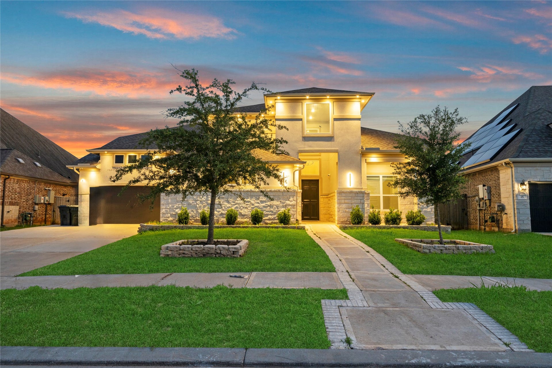 11 Victorian Run, Sugar Land, TX 77498 Stunning contemporary home with breathtaking twilight curb appeal, elegant stone & stucco elevation, and beautifully manicured landscaping.
