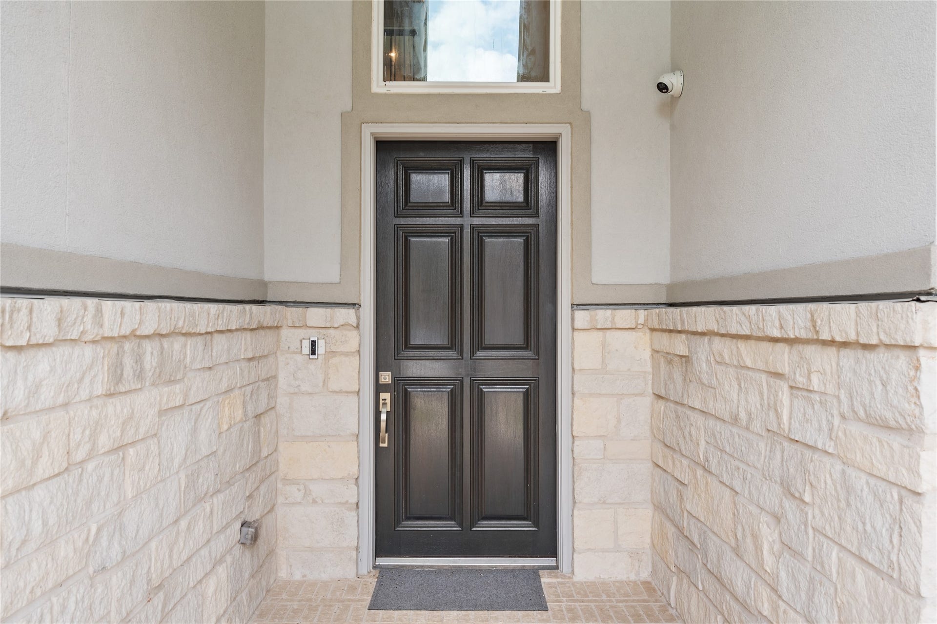 11 Victorian Run, Sugar Land, TX 77498 Inviting covered front entry featuring a stylish front door, stone-accent walls, and a private walkway that creates a warm and welcoming first impression.