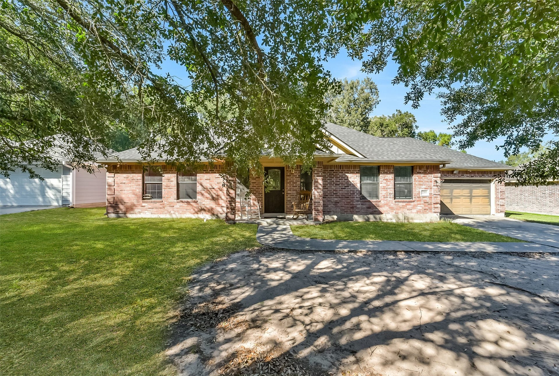 22911 Keith Drive, New Caney, TX 77357 Nestled beneath mature shade trees, this charming one-story brick home offers three bedrooms, two full bathrooms, and a two-car garage.
