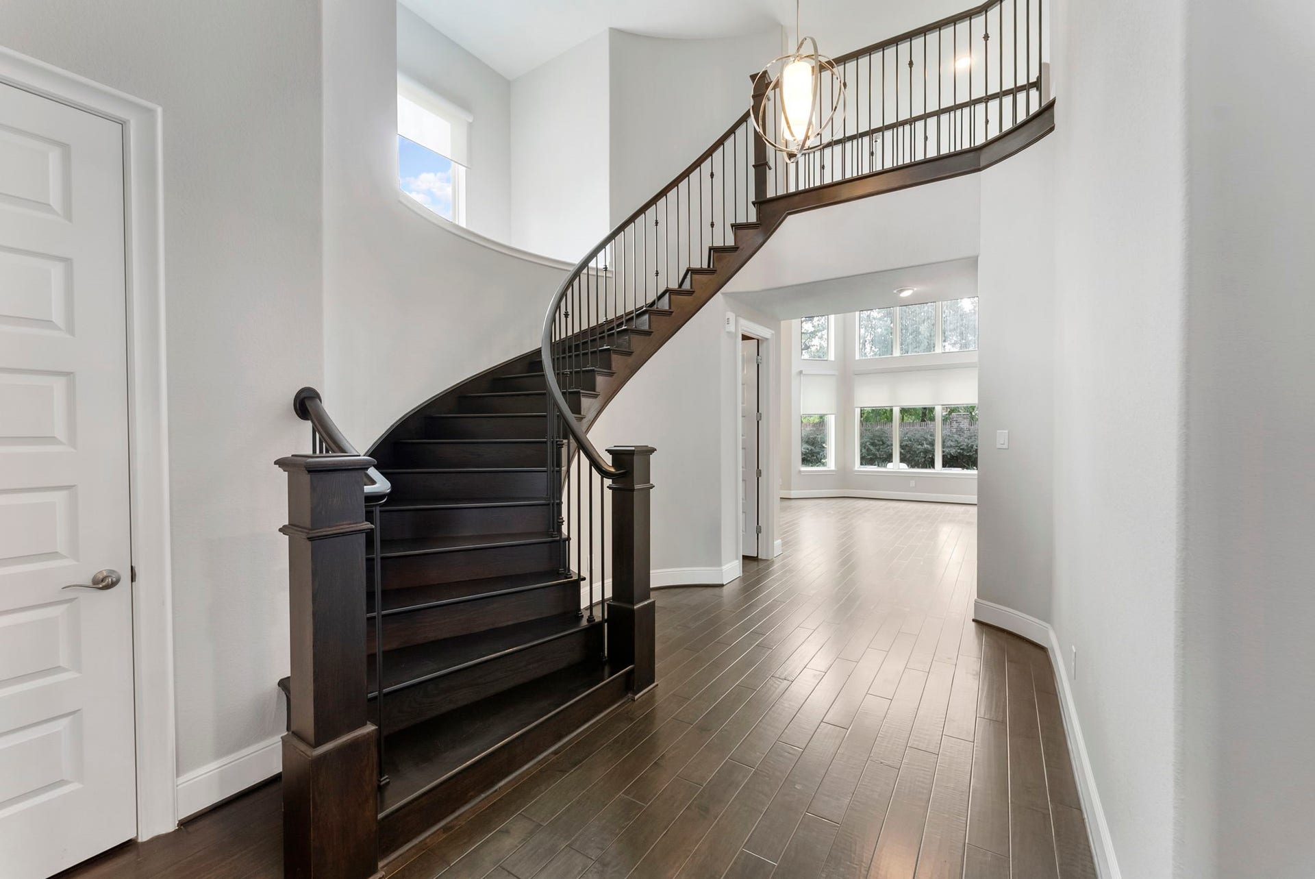 The stunning curved staircase leads to the private second-story living spaces.