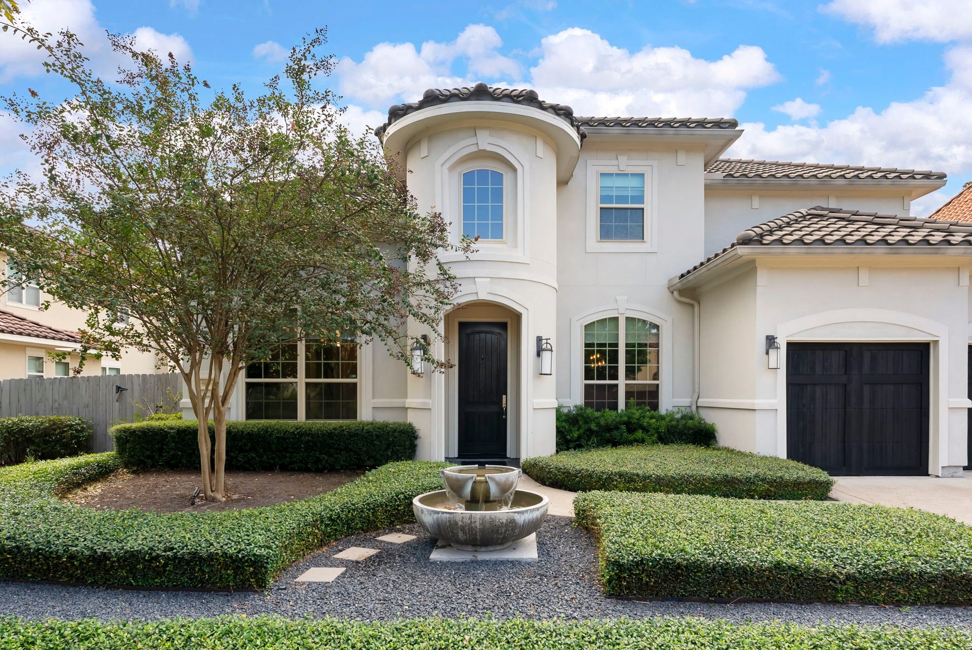 Professionally landscaped front yard with pristine curb appeal