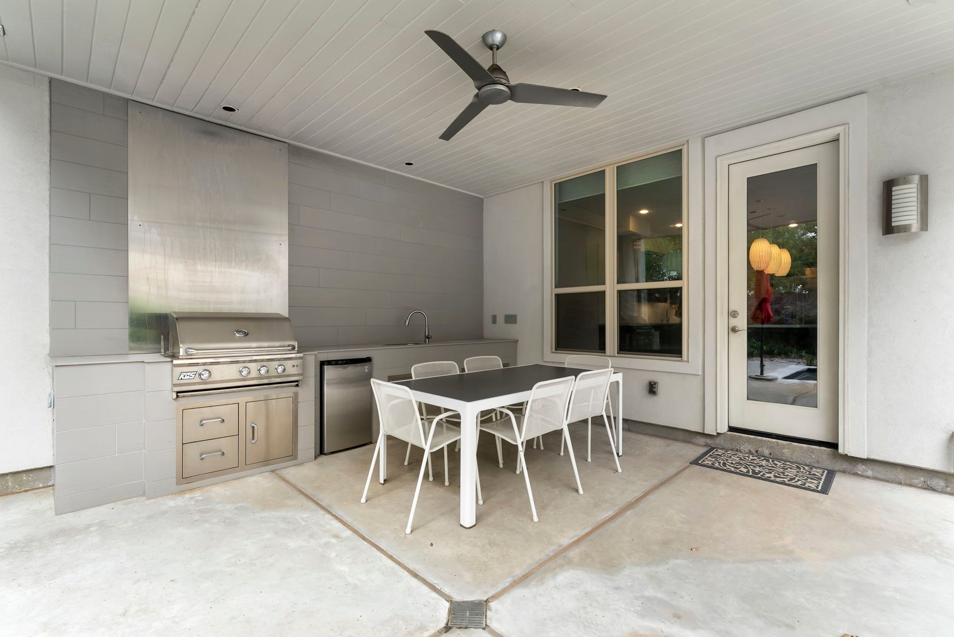 Summer kitchen with built-in grill & pool view for year round enjoyment!