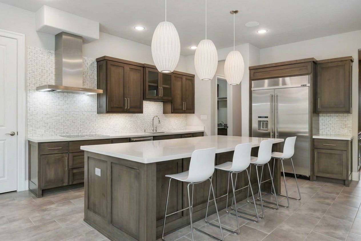 Stunning  kitchen featuring an extra-large island with ample seating space. (Virtually staged)