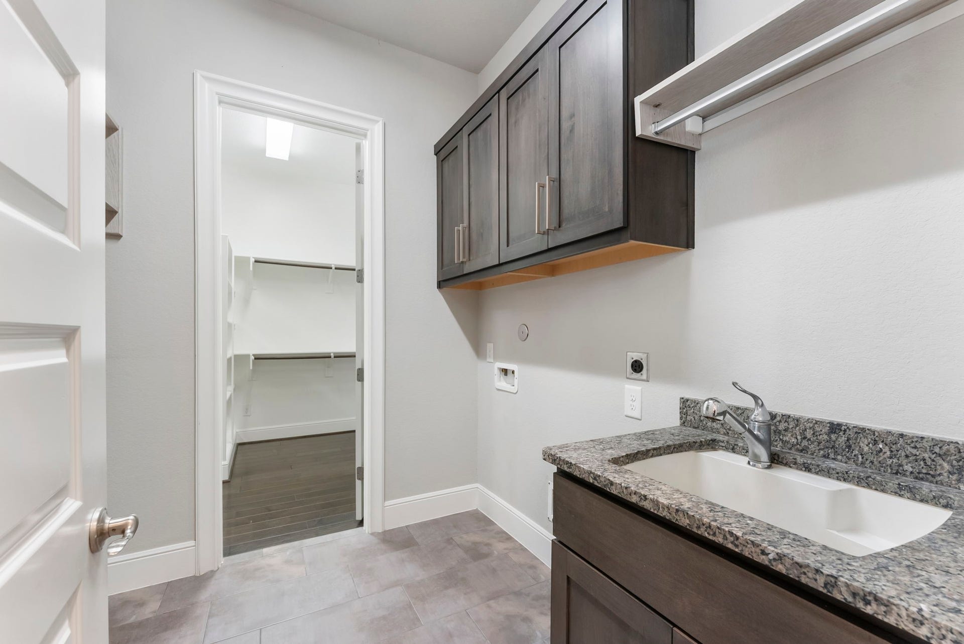 The oversized primary closet directly connects to the utility room.