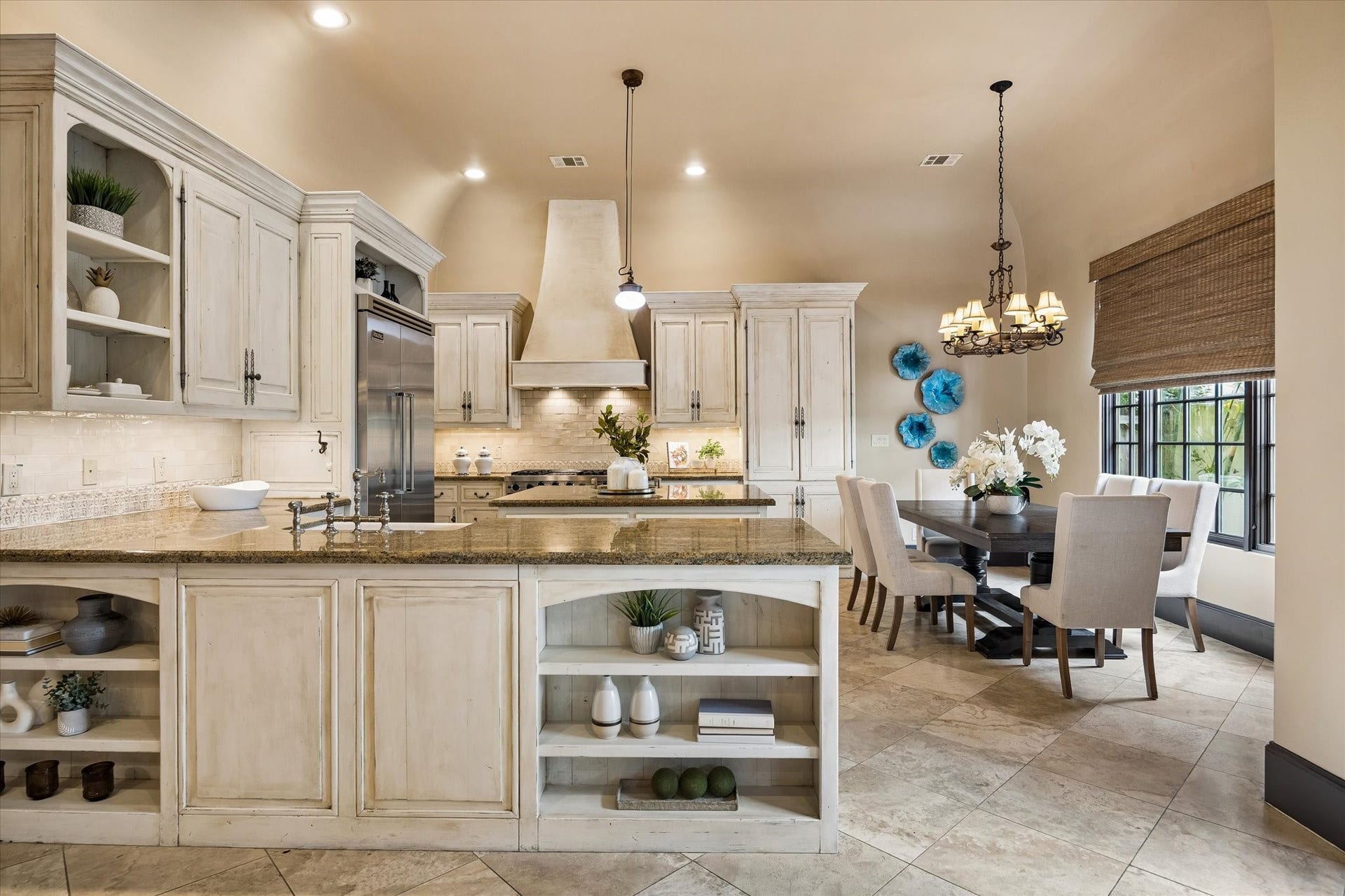 5120 Mt Vernon, Houston, TX 77006 At the back of the house the island kitchen sports designer backsplash tile, stainless steel Wolf appliance package and distressed cabinet finish. As in all of the first floor rooms, the high ceilings are coved at the corners.