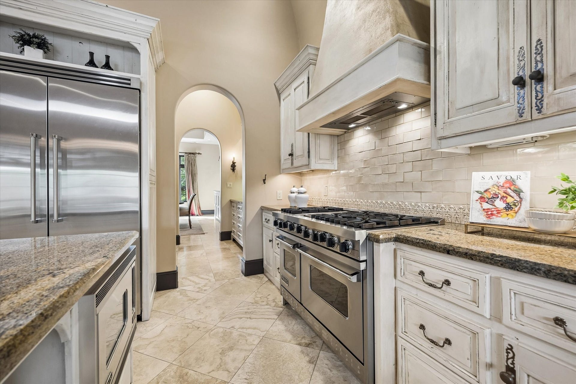 5120 Mt Vernon, Houston, TX 77006 View from the kitchen through the Butler's Pantry to the dining room. Note the gas range with two ovens, multiple burners and griddle.
