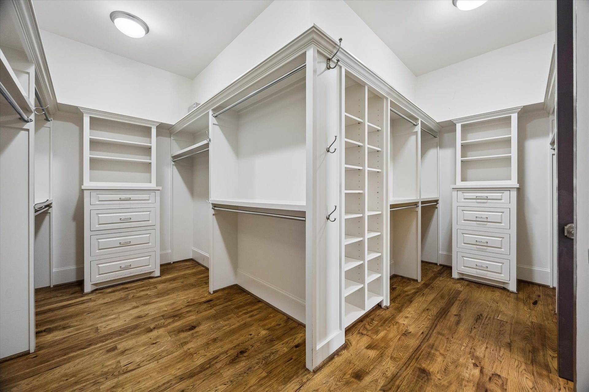 5120 Mt Vernon, Houston, TX 77006 Primary closet with tons of hanging space, shoe racks and cabinets. Pecan hardwoods.
