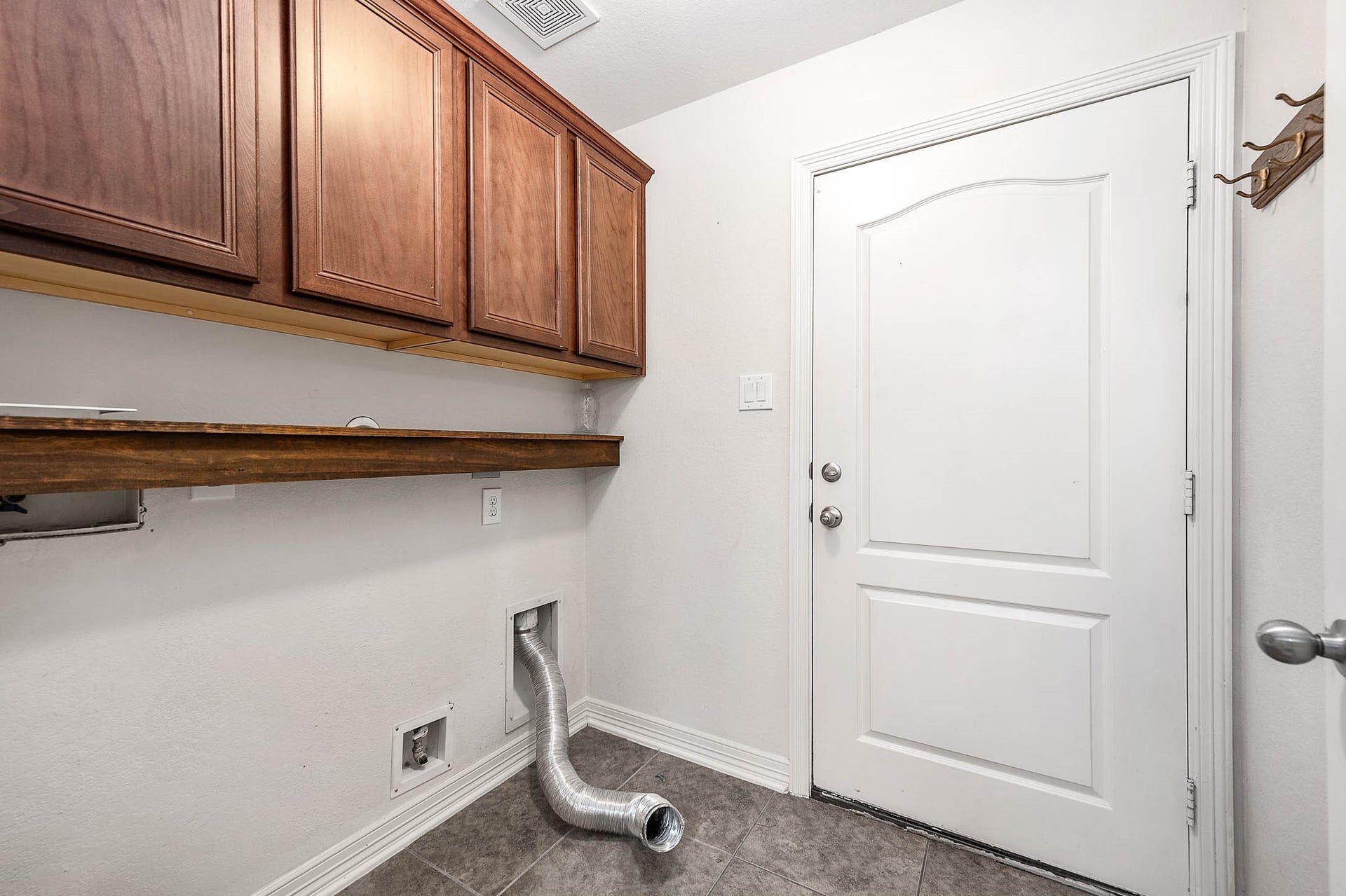 The utility room offers ample storage space and convenient access to the garage.
