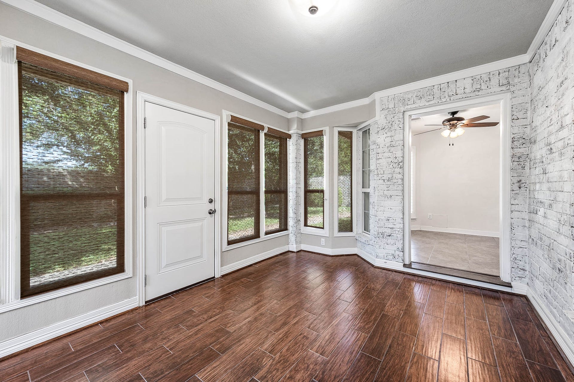 Experience serenity in this inviting sunroom, featuring large windows that flood the space with natural light and offer picturesque views of the lush outdoors.