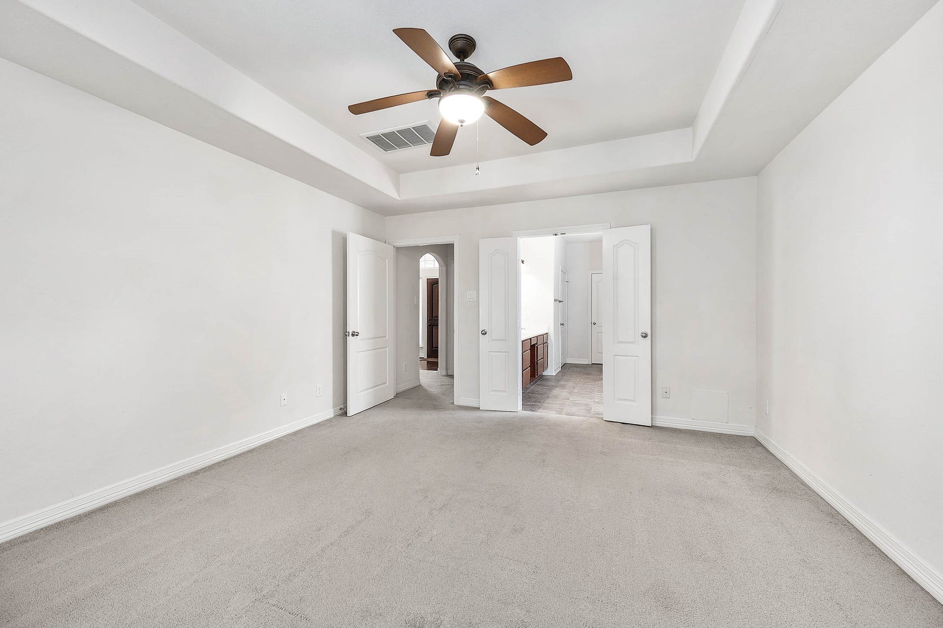 Step into the spacious primary suite with seamless access to a luxurious bathroom, offering both comfort and convenience.