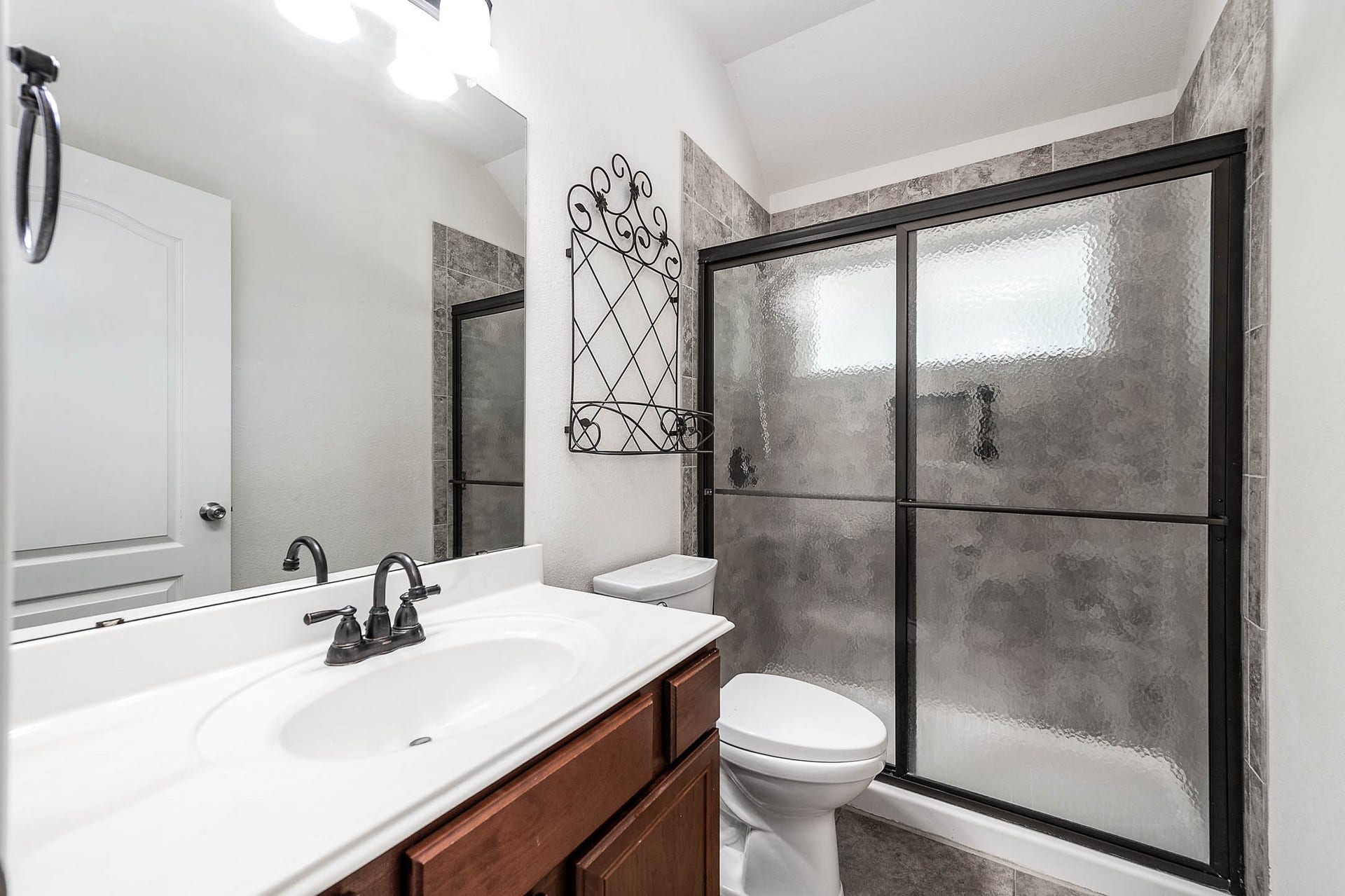 Experience comfort and versatility in the secondary bathroom, featuring a sleek tub/shower combination.
