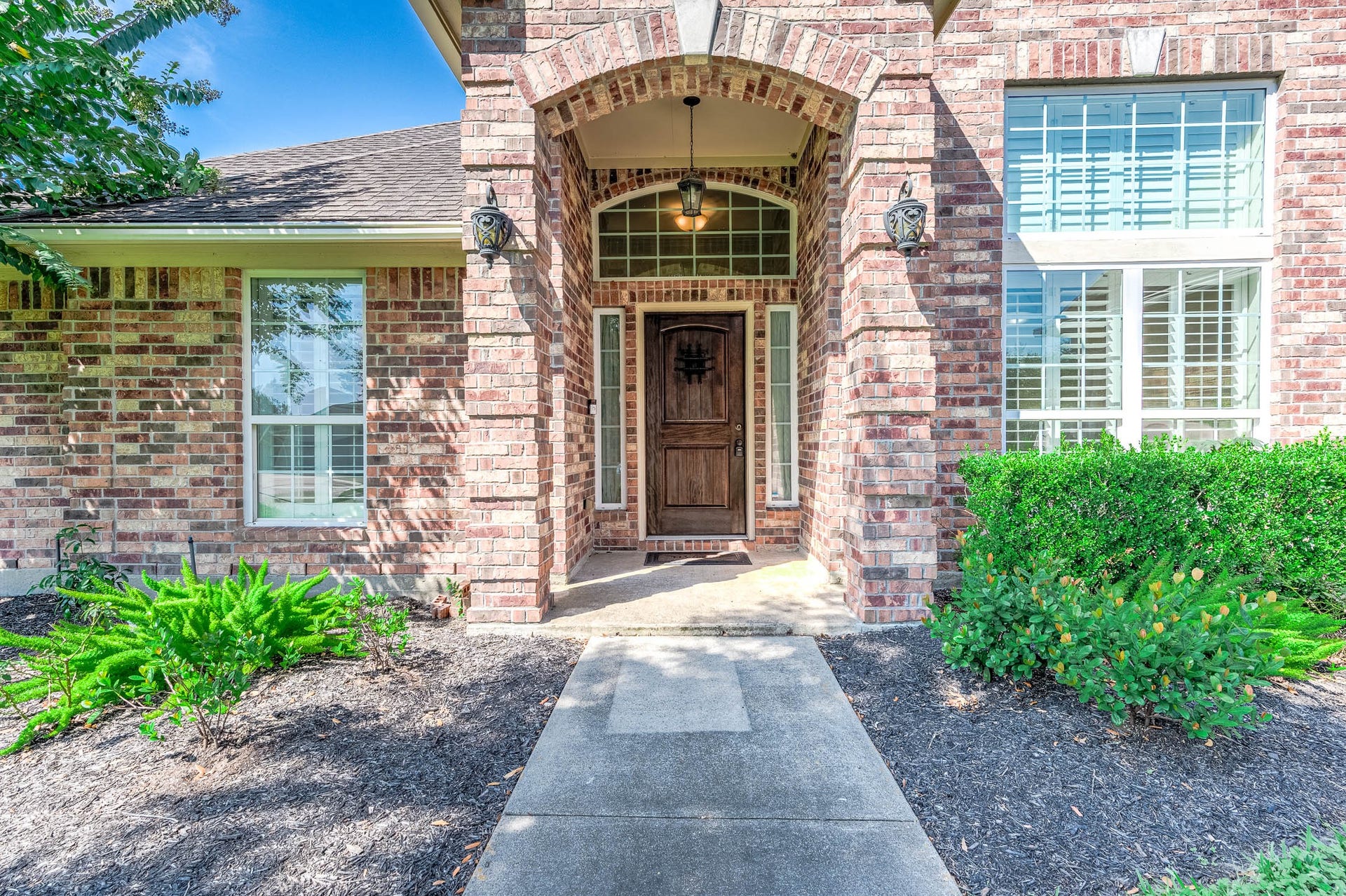 A grand entrance welcomes you with a charming covered porch, blending elegance and warmth.