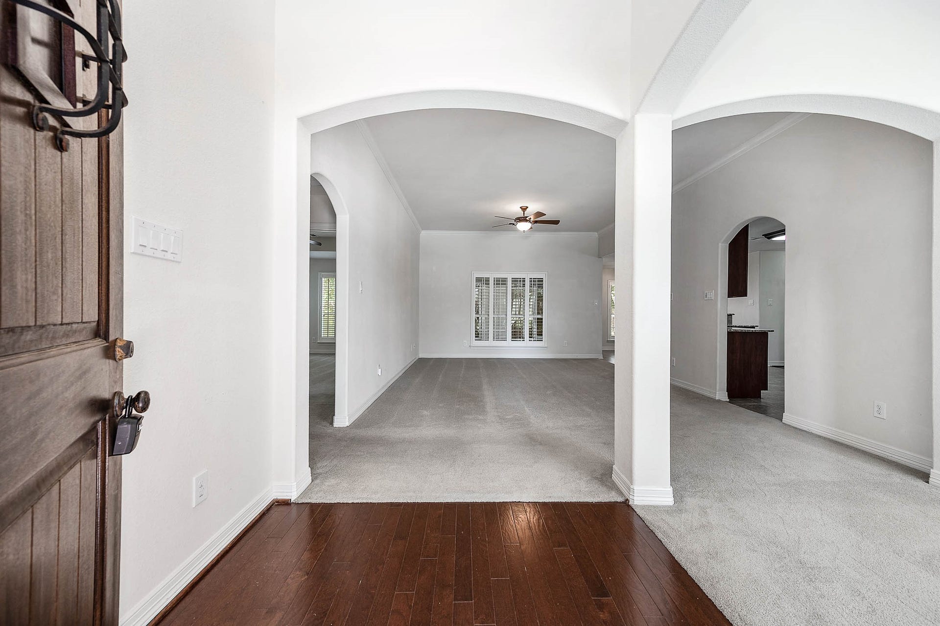 Step through the inviting front door into a spacious family room seamlessly connected to elegant formal dining areas.