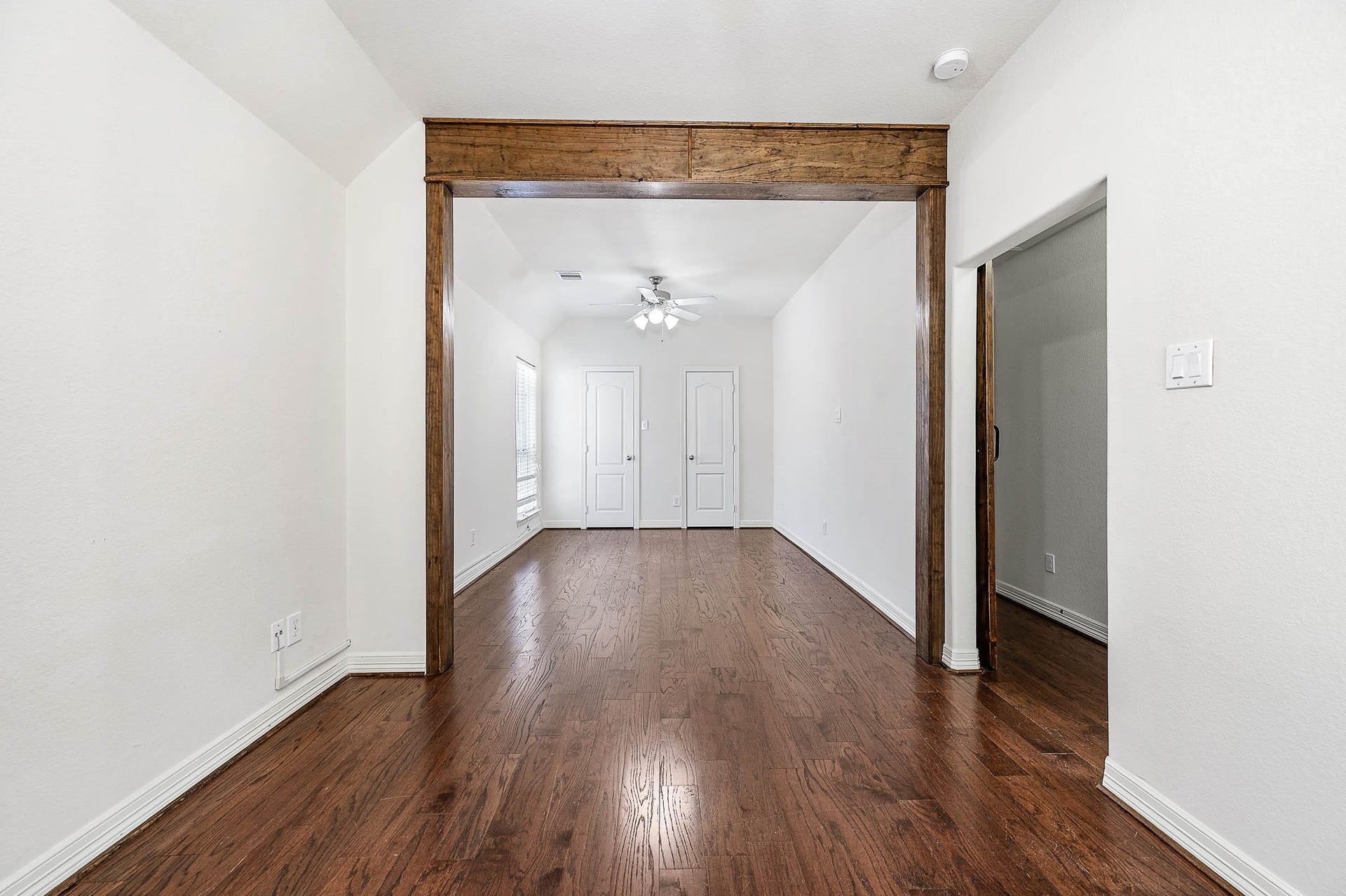Spacious downstairs bedroom offers versatile potential, easily transforming back into two separate rooms to suit your lifestyle needs.