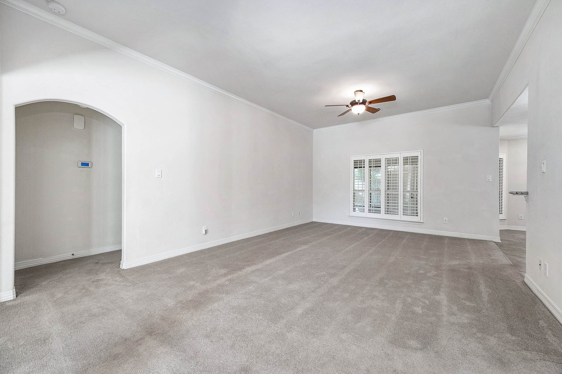 A generously spacious living room perfect for accommodating bulky furniture, seamlessly connecting to the inviting breakfast area and kitchen.