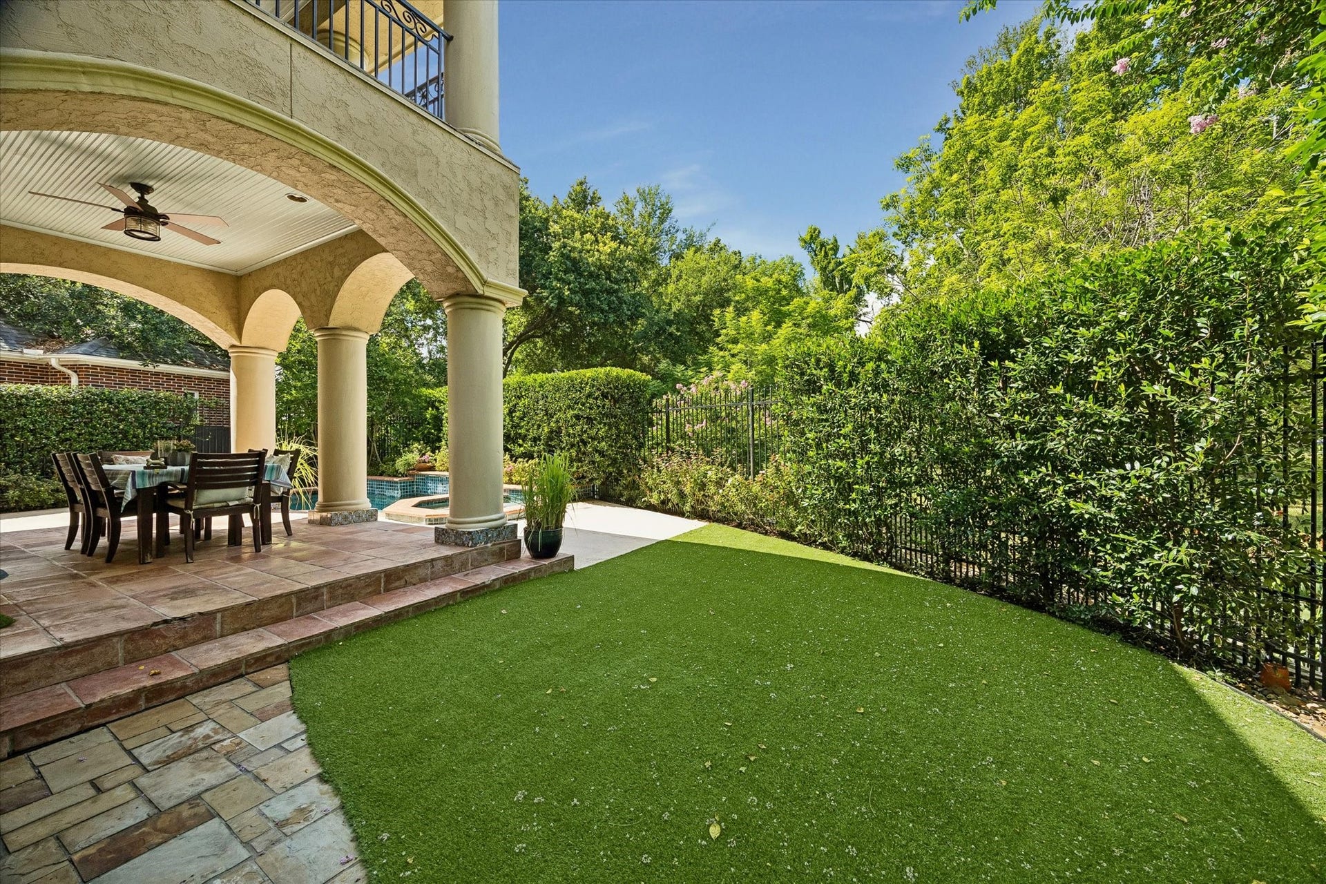 Green space off the large covered patio and pool area.
