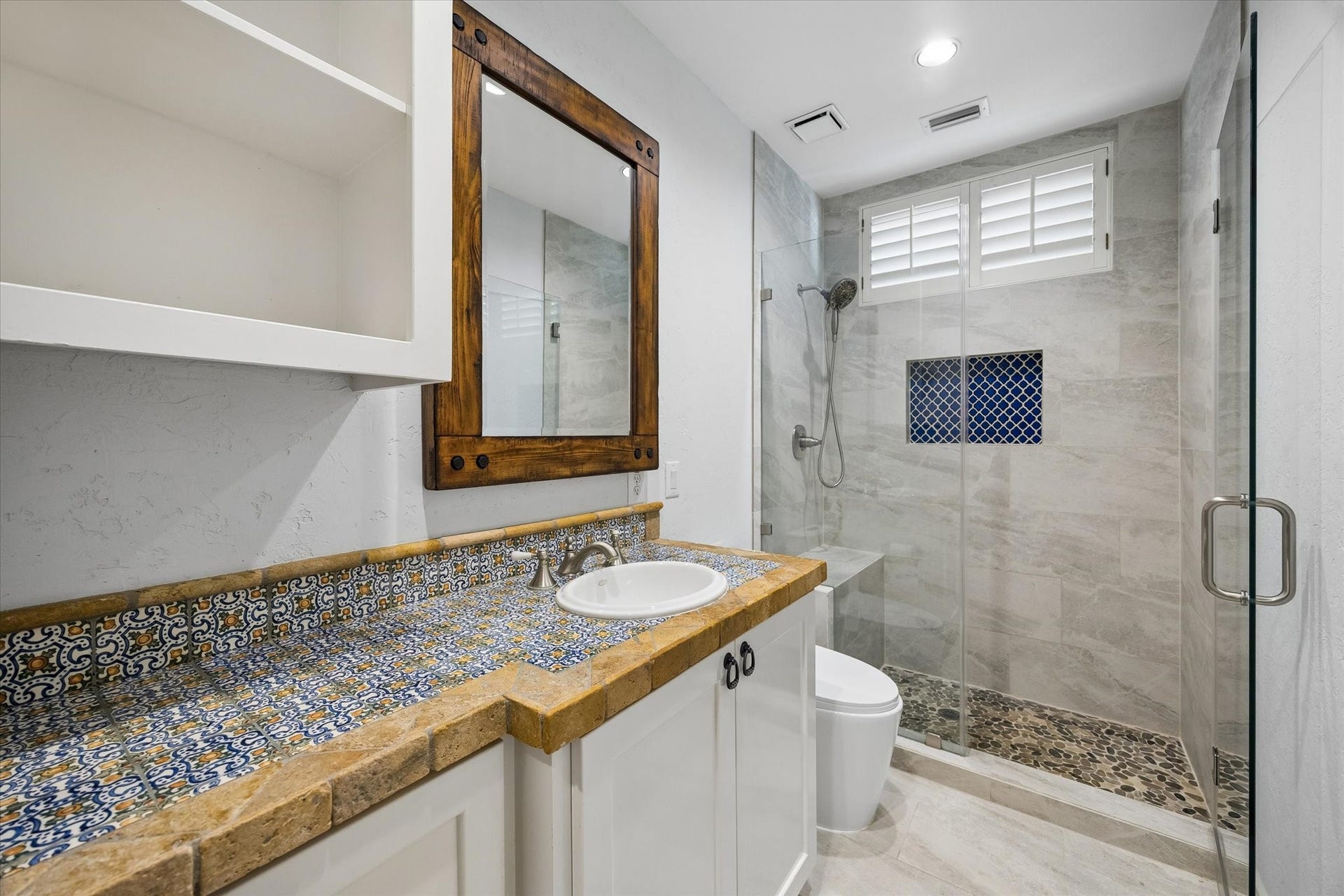 Downstairs full bath with frameless glass walk-in shower.