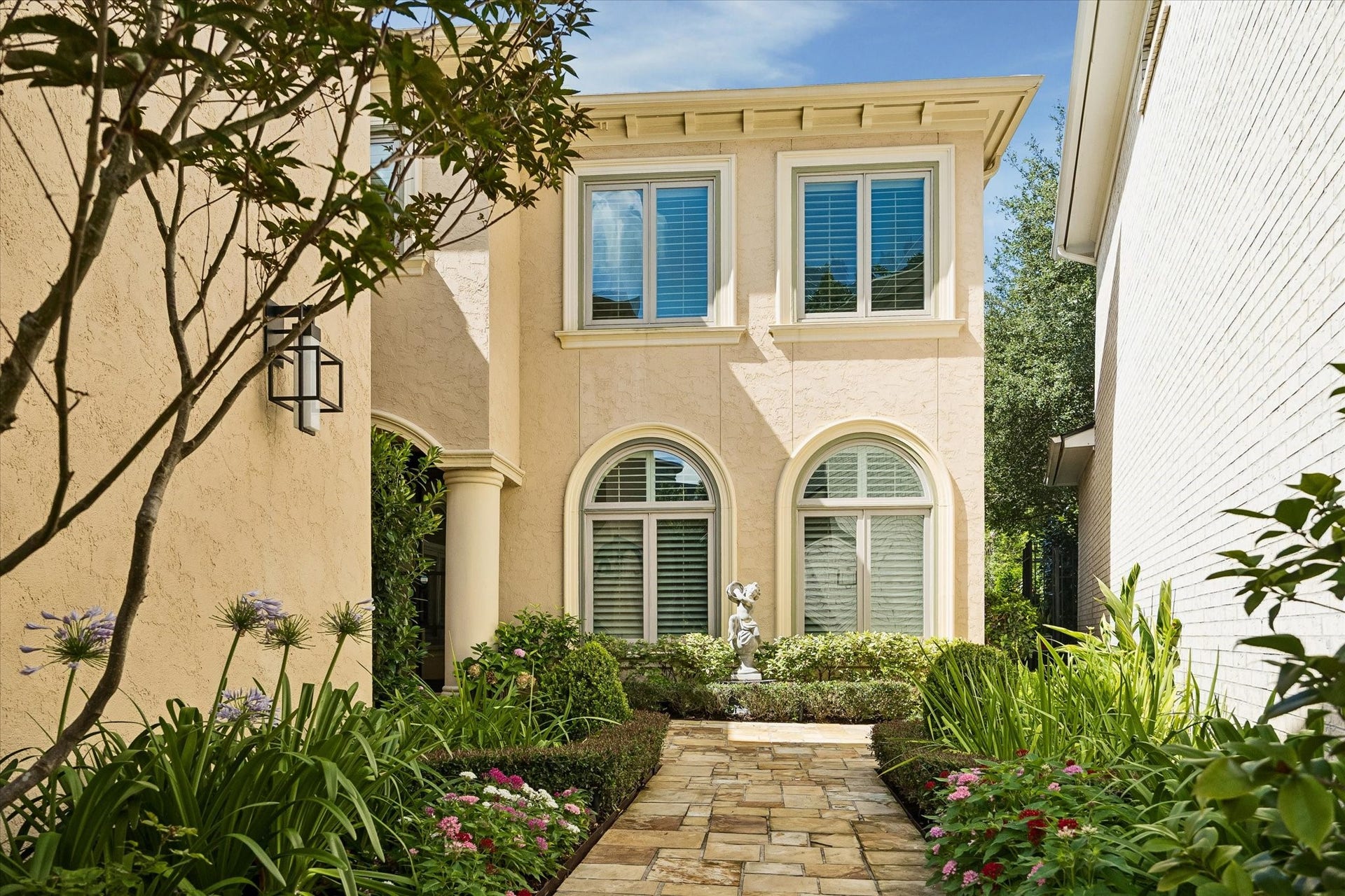 Front porch entry with paved walkway.