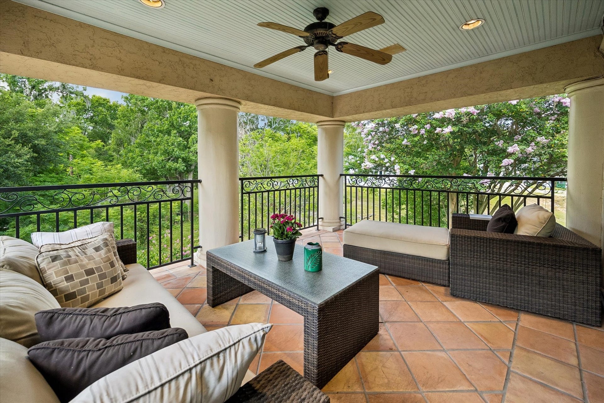 Balcony off primary suite with lush tree views overlooking the pool and spa.