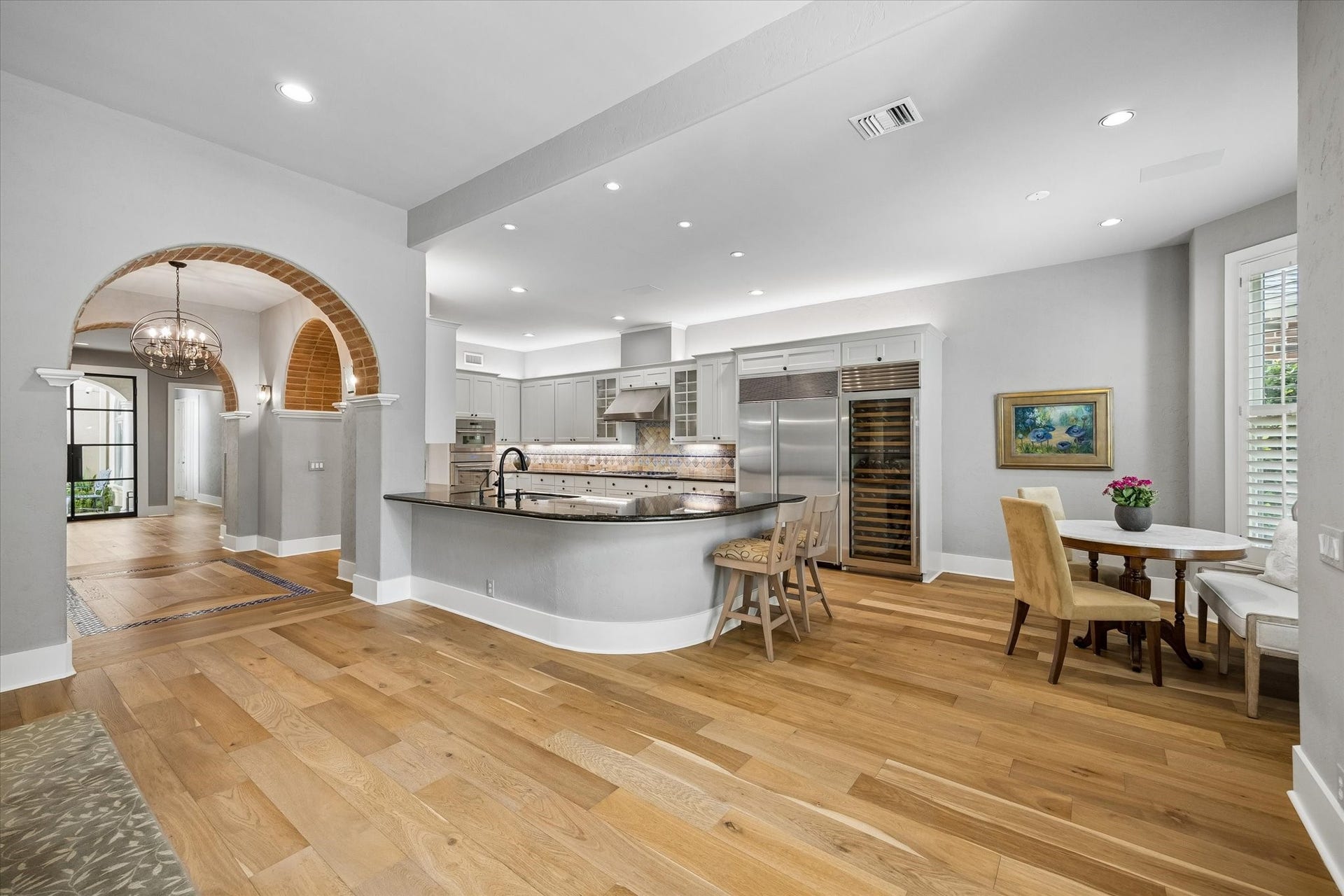 Spacious open kitchen with rounded breakfast bar to the breakfast room.
