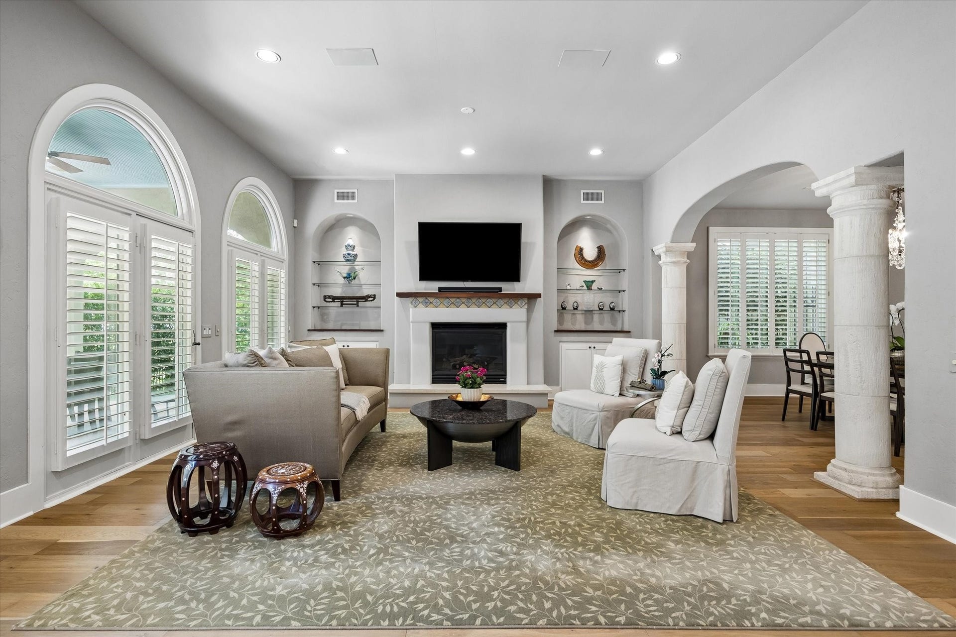 Gorgeous fireplace flanked by built-in display shelving and custom lighting.